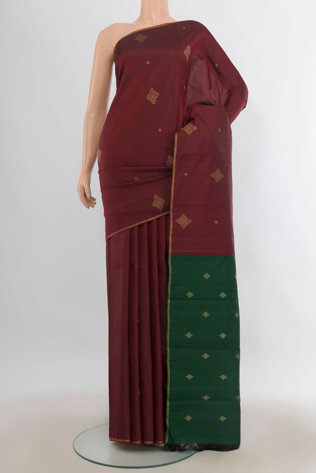 Pure Silk Pure Zari Maroon Kanchipuram Saree with Zari Butta on the body and Zari Border.  displayed on a mannequin