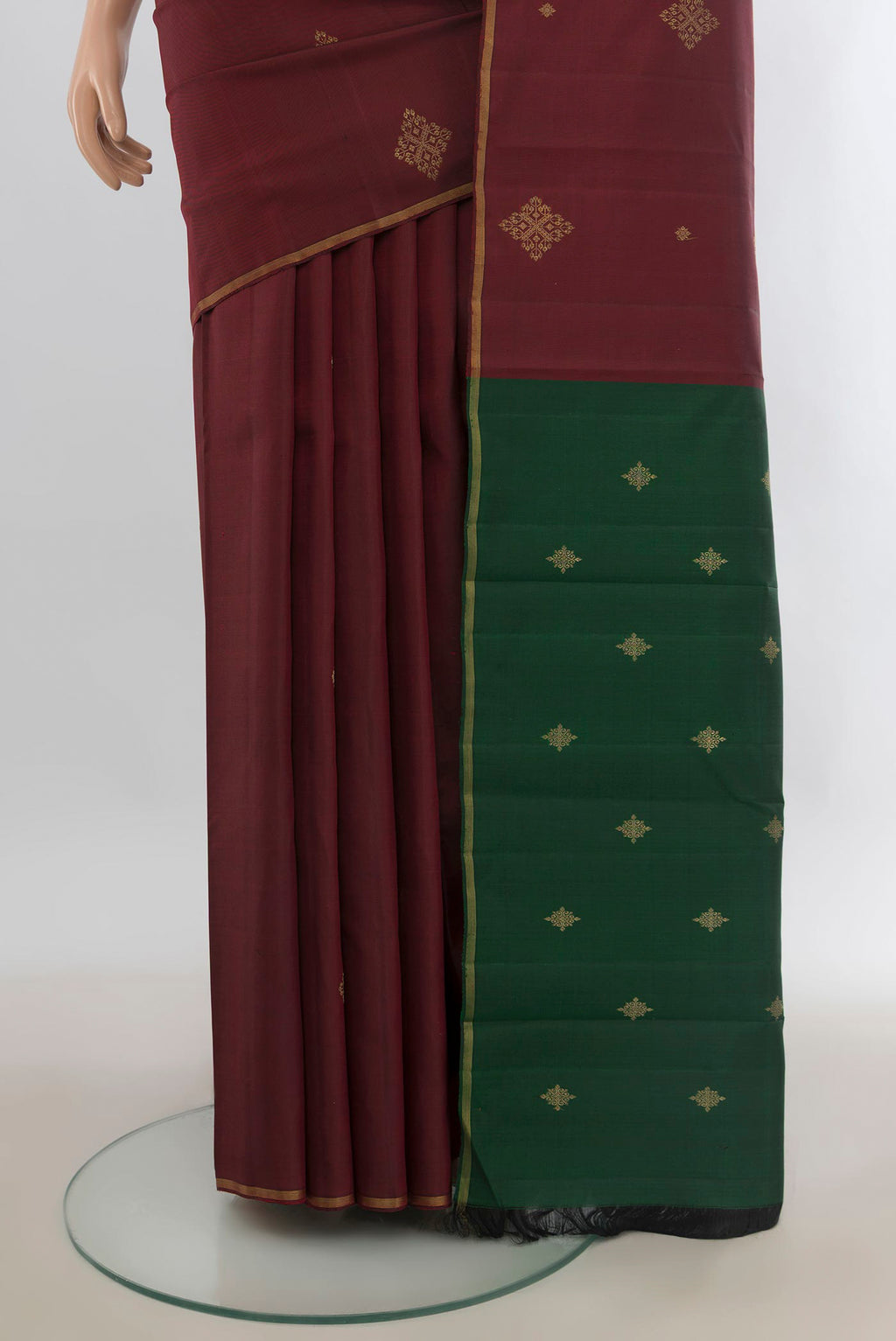 Pleats and pallu of Pure Silk Pure Zari Maroon Kanchipuram Saree with Zari Butta on the body and Zari Border. 