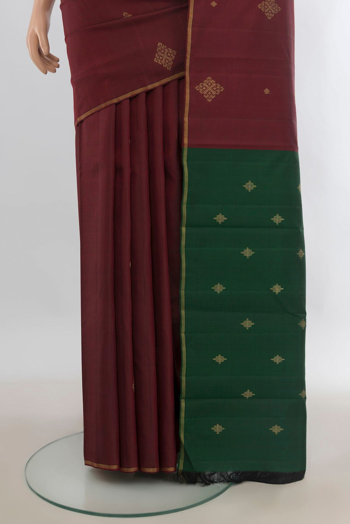 Pleats and pallu of Pure Silk Pure Zari Maroon Kanchipuram Saree with Zari Butta on the body and Zari Border. 