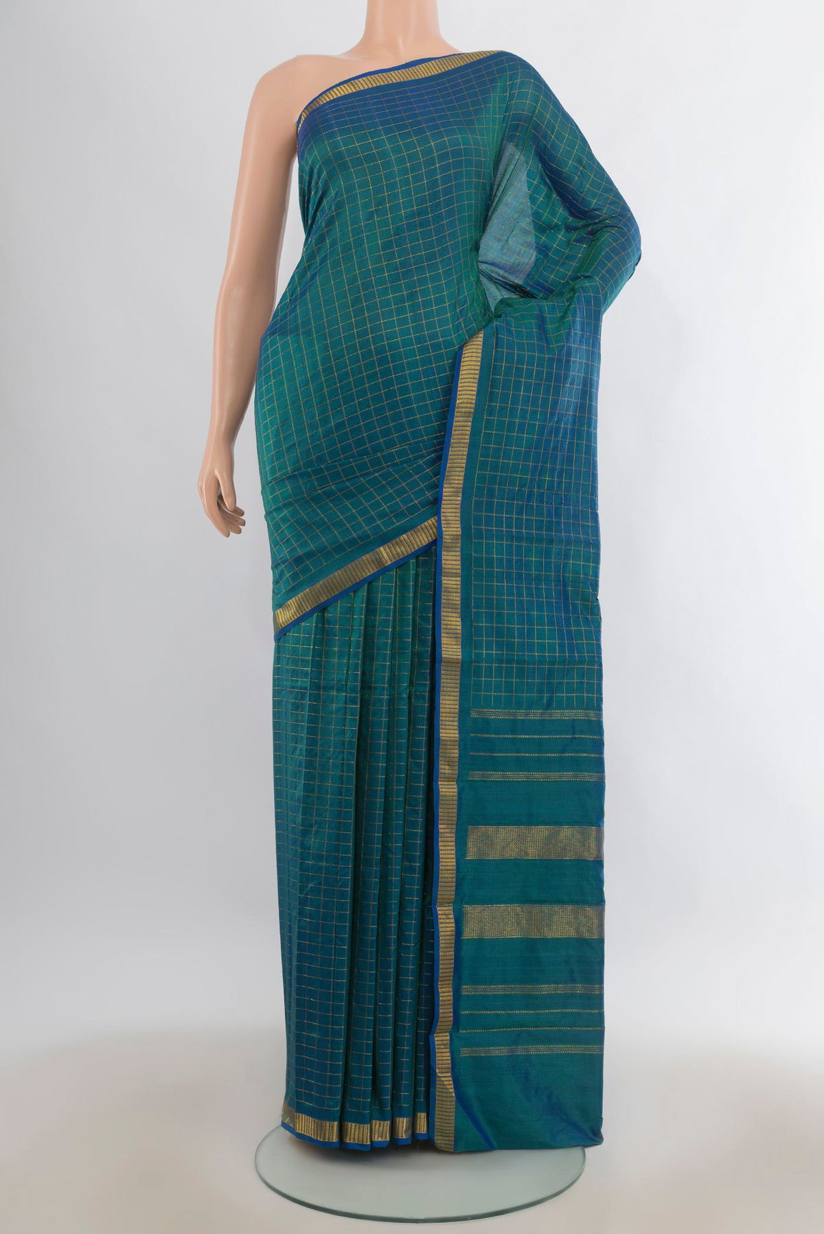 Pure Silk Peacock Blue Kanchipuram Saree with Checked design on the body and Zari Border.  displayed on a mannequin