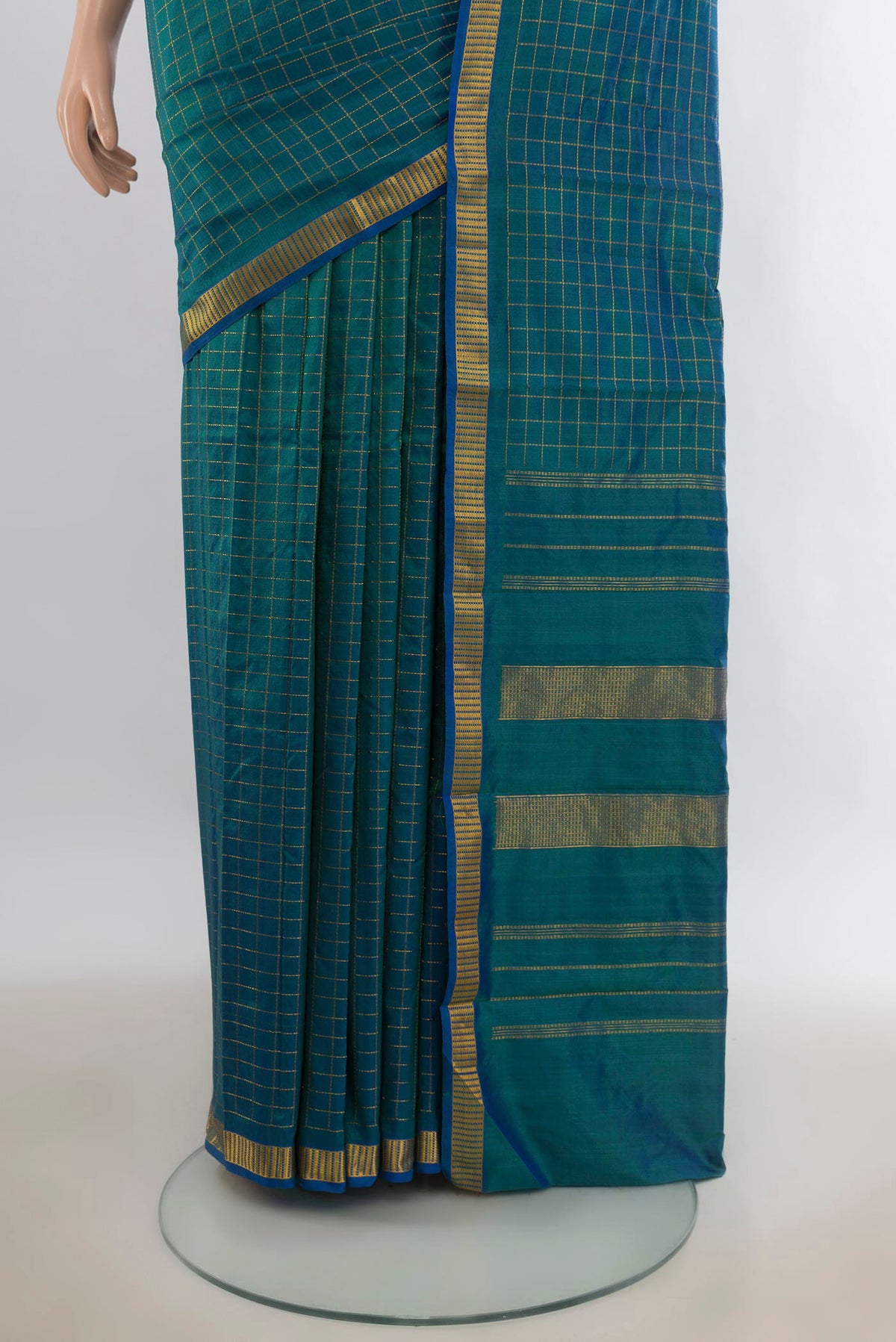 Pleats and pallu of Pure Silk Peacock Blue Kanchipuram Saree with Checked design on the body and Zari Border. 