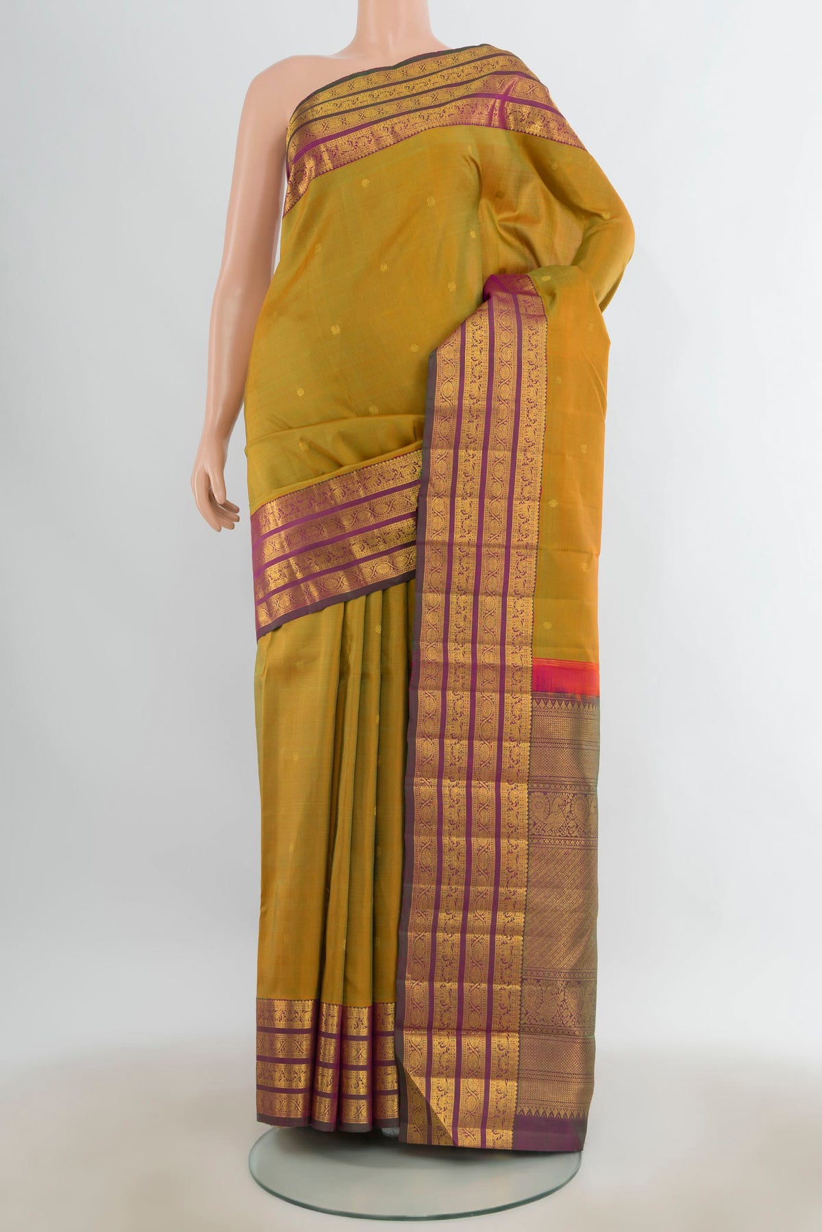 Pure Silk Mehandi Green Kanchipuram Saree with Zari Butta on the body and Zari Border.  displayed on a mannequin
