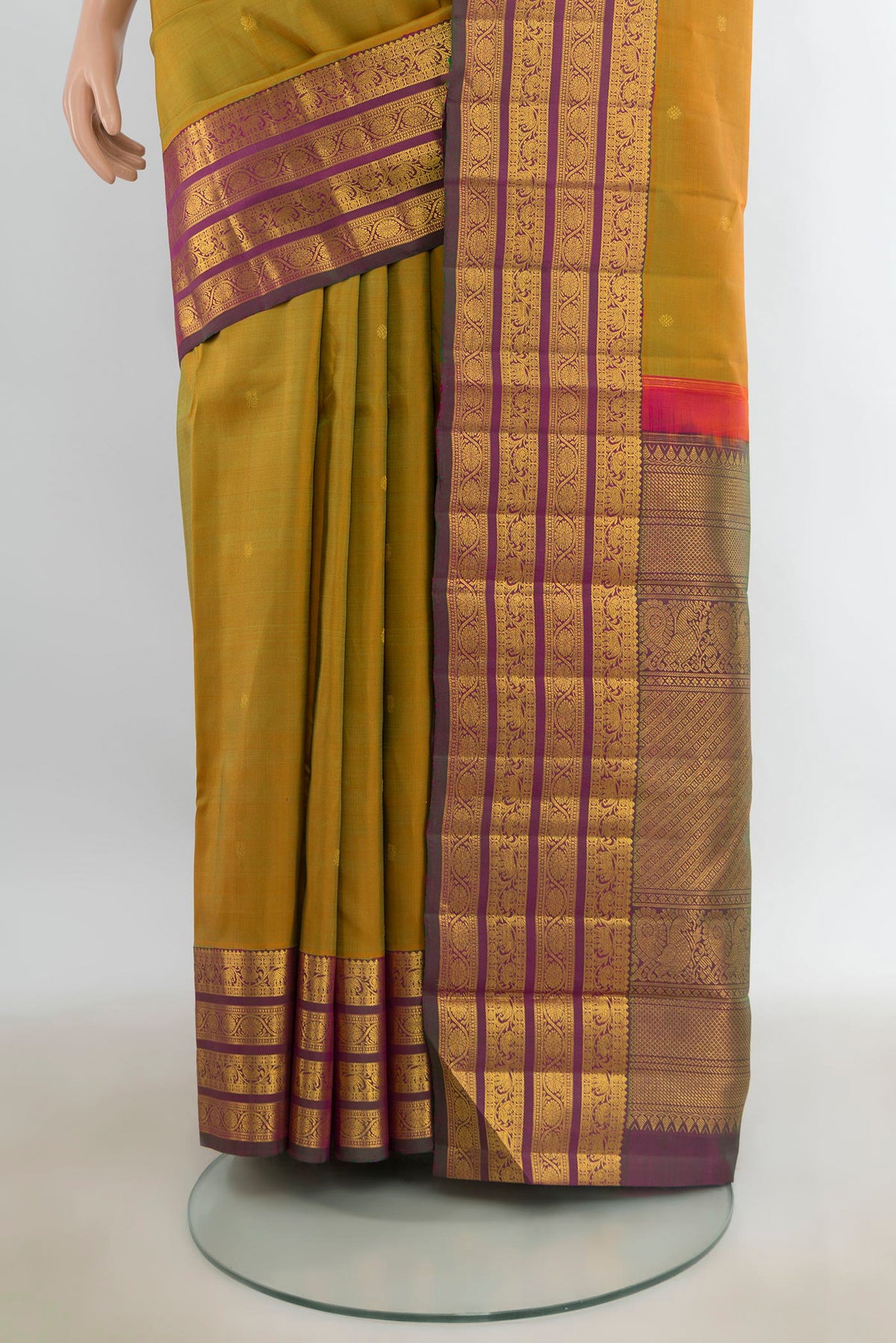Pleats and pallu of Pure Silk Mehandi Green Kanchipuram Saree with Zari Butta on the body and Zari Border. 