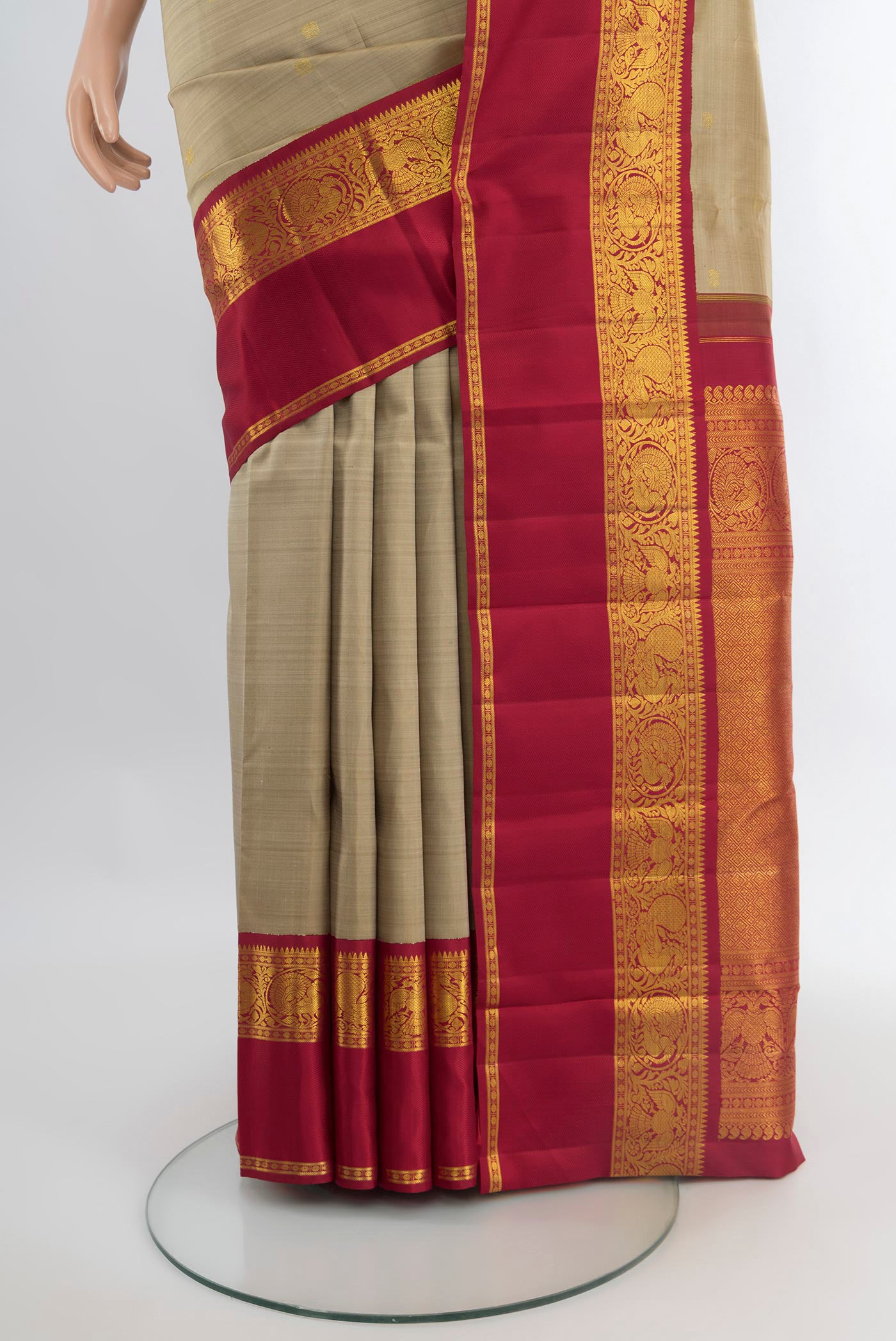 Pleats and pallu of Beige Kanchipuram Silk Saree with Zari Butta on the body and Zari Border. 