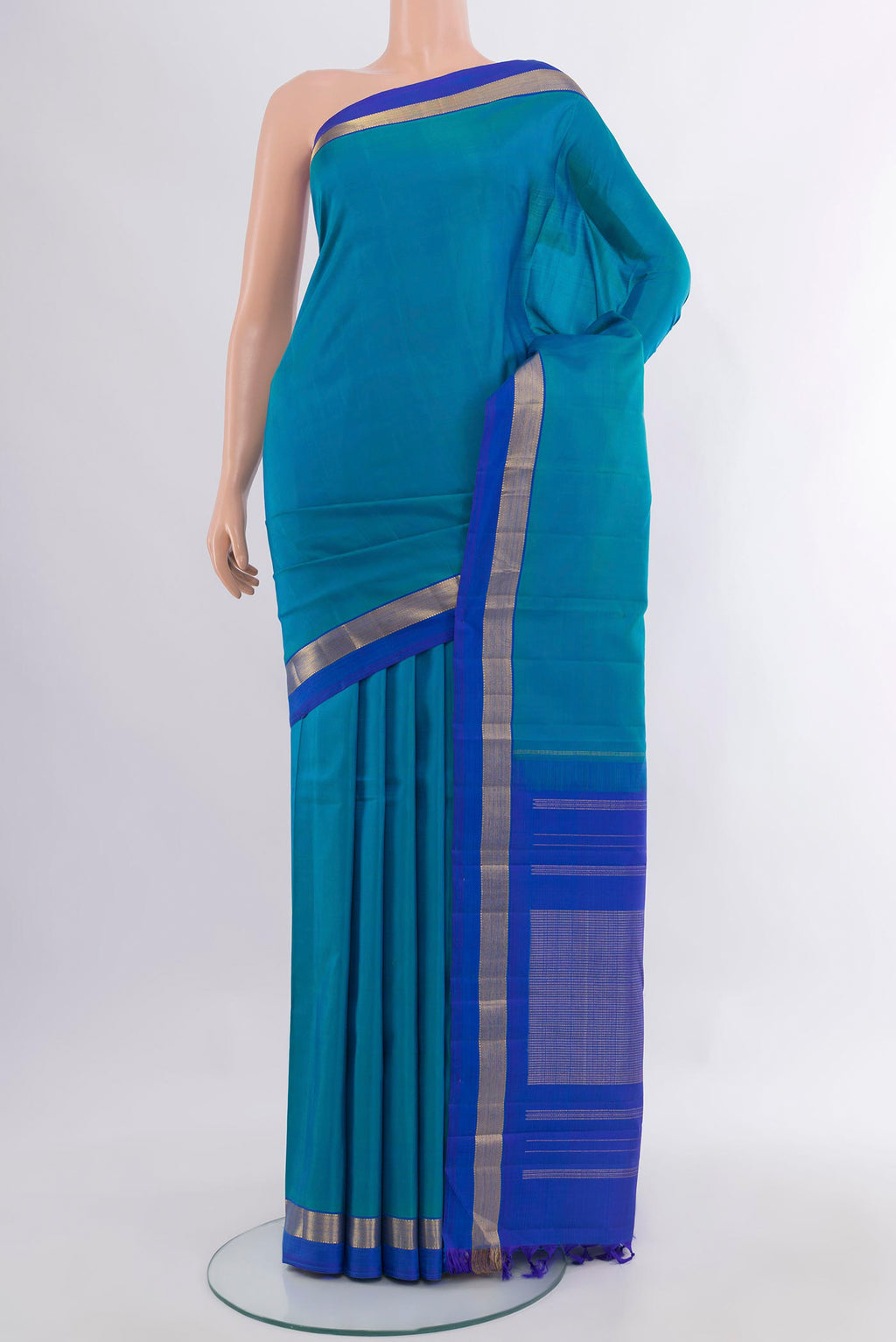 Pure Silk Peacock Blue Kanjivaram Saree with Plain Body and Zari Border.  displayed on a mannequin