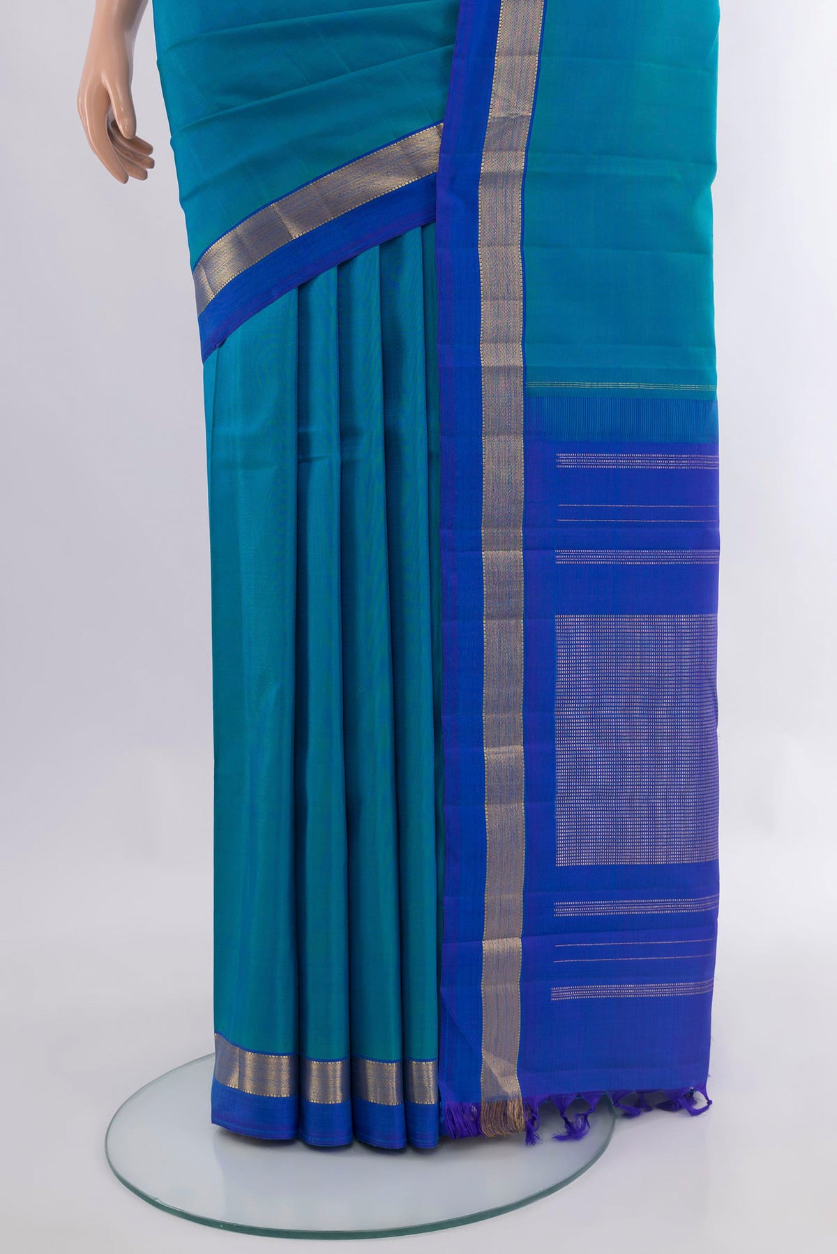 Pleats and pallu of Pure Silk Peacock Blue Kanjivaram Saree with Plain Body and Zari Border. 