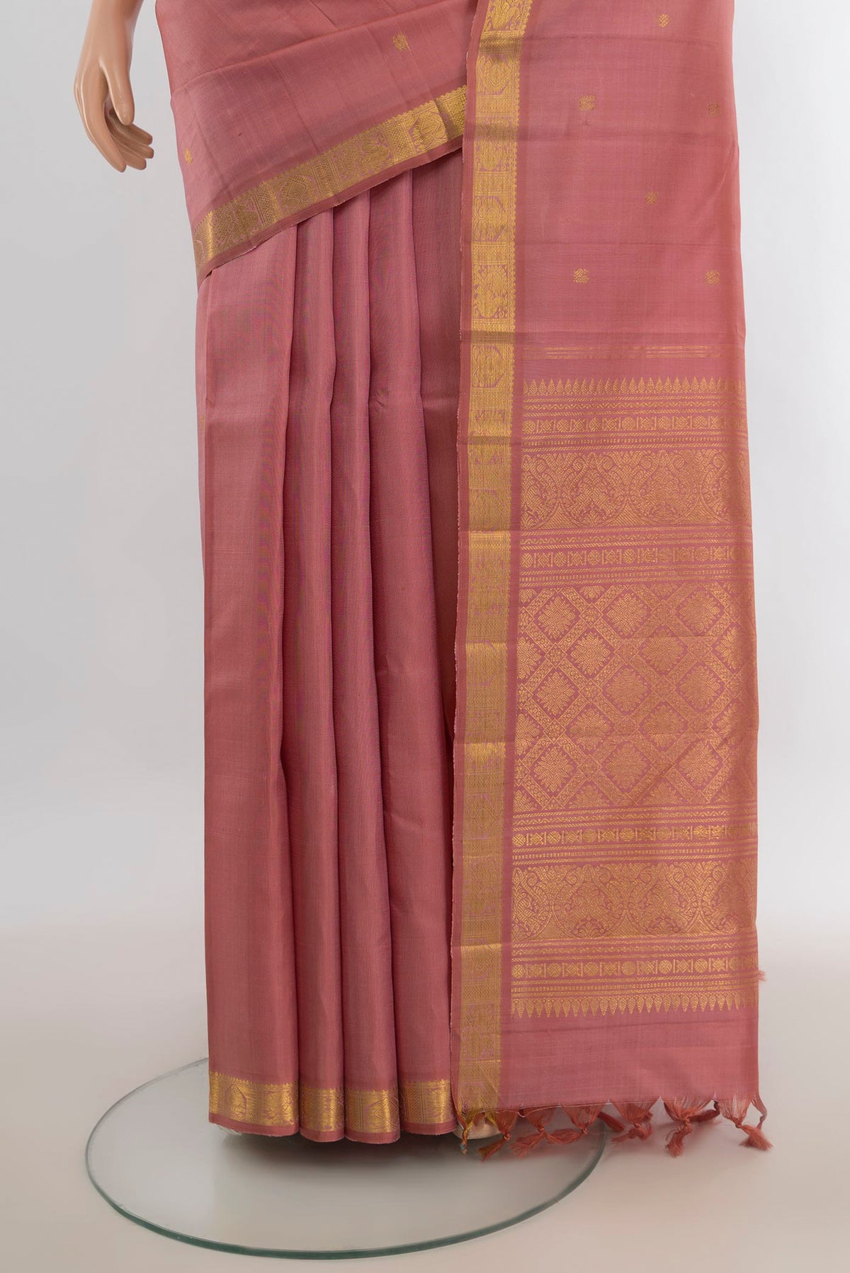 Pleats and pallu of Pure Silk Rose Gold Kanjivaram Saree with Zari Butta on the body and Silk Border. 