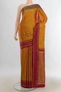 Pure Silk Mustard Kanjivaram Saree with Zari Butta on the body and Silk Border.  displayed on a mannequin