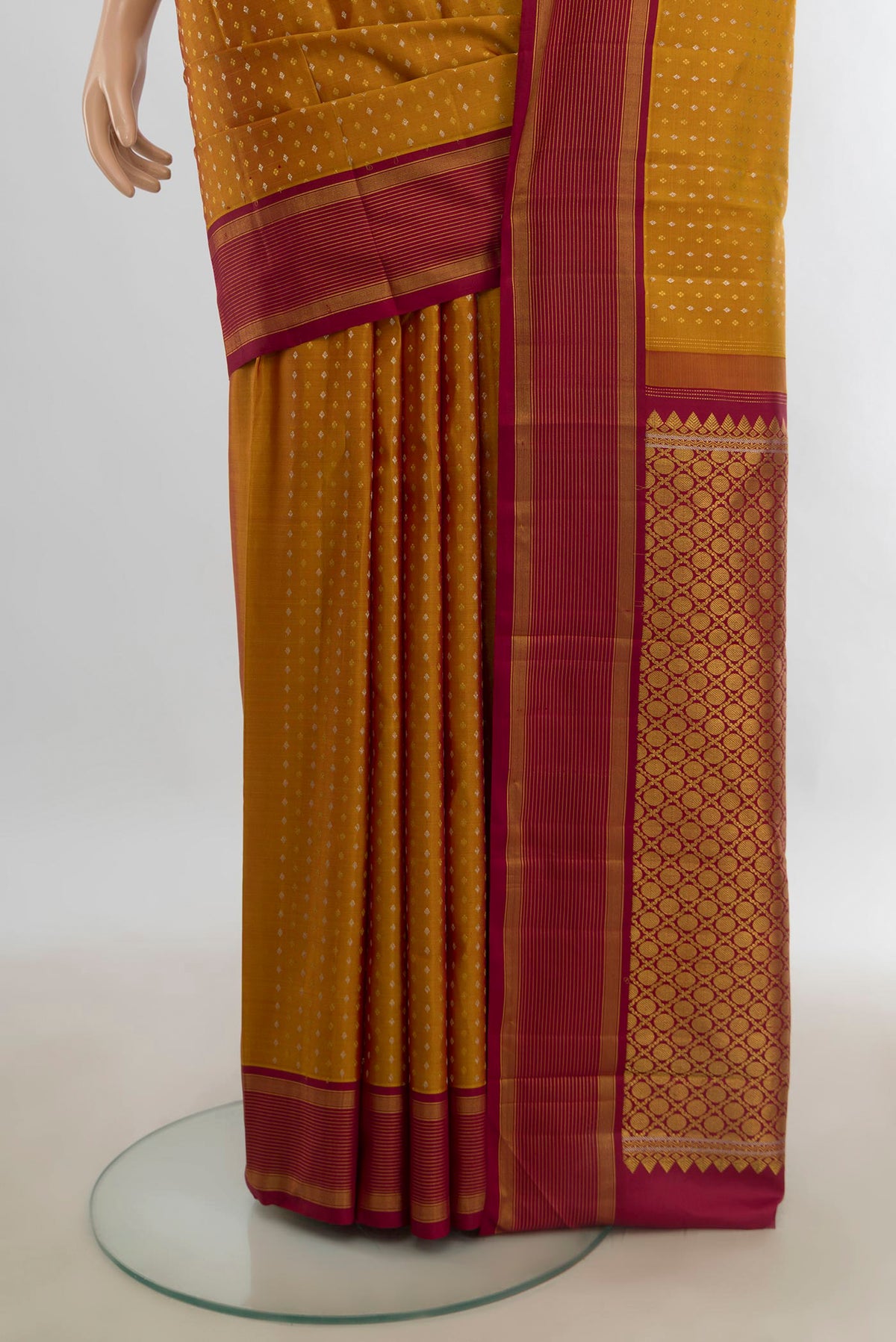 Pleats and pallu of Pure Silk Mustard Kanjivaram Saree with Zari Butta on the body and Silk Border. 