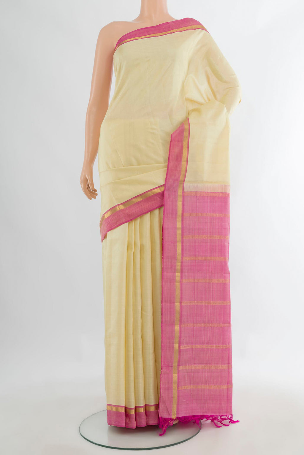 Pure Silk Cream Kanjivaram Saree with Plain Body and Plain Border.  displayed on a mannequin