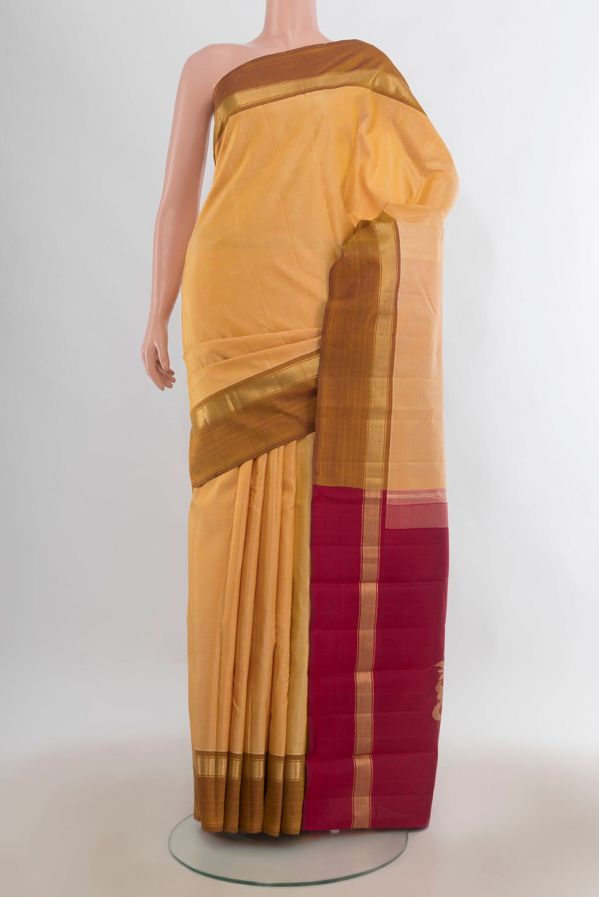 Pure Silk Sandal Kanchipuram Saree with Plain Body and Plain Border.  displayed on a mannequin
