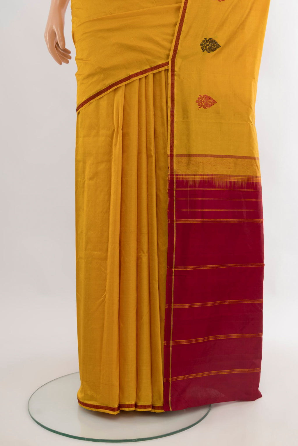 Pleats and pallu of Mustard Kanchipuram Silk Saree with Plain Body and Thread Border. 