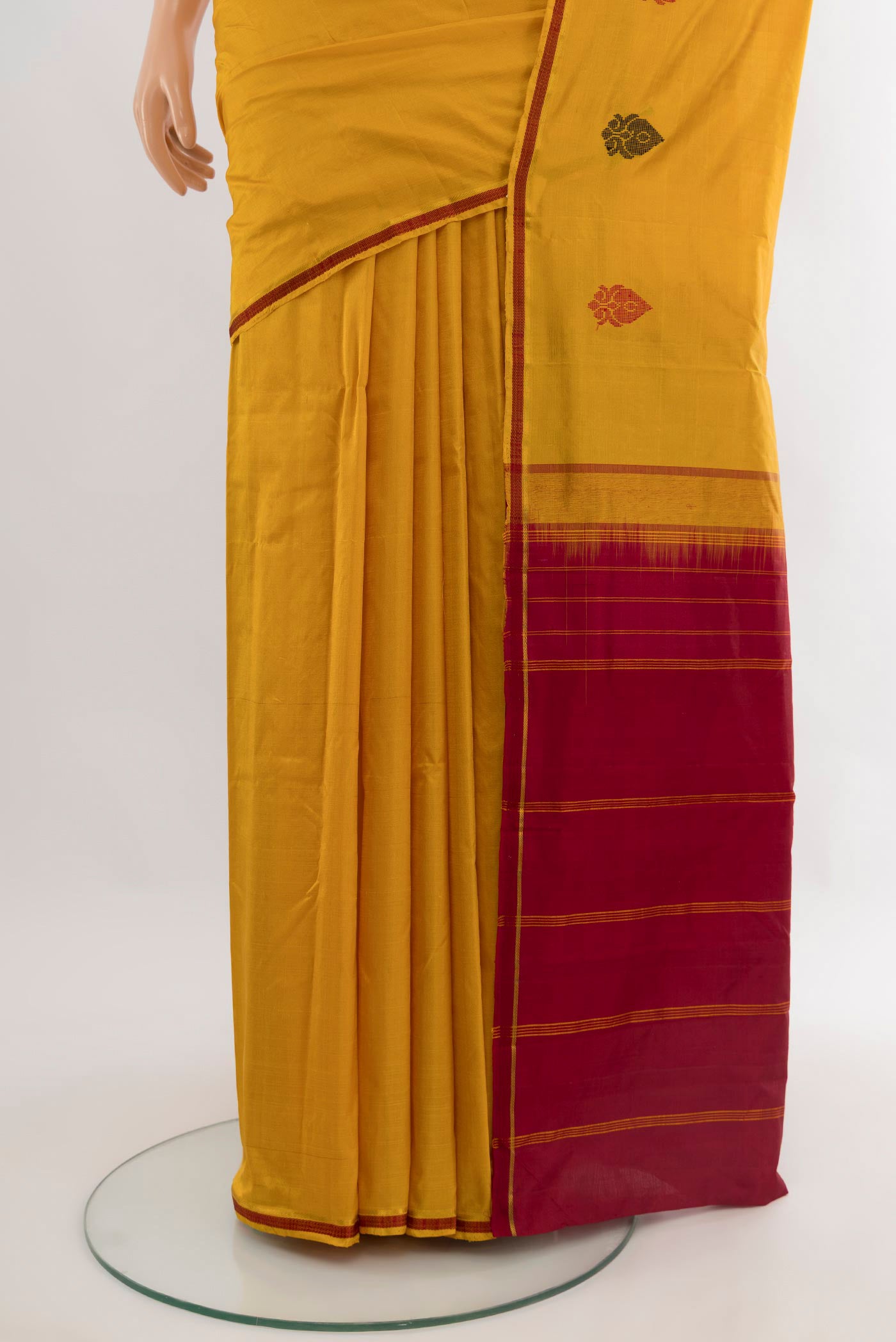 Pleats and pallu of Mustard Kanchipuram Silk Saree with Plain Body and Thread Border. 