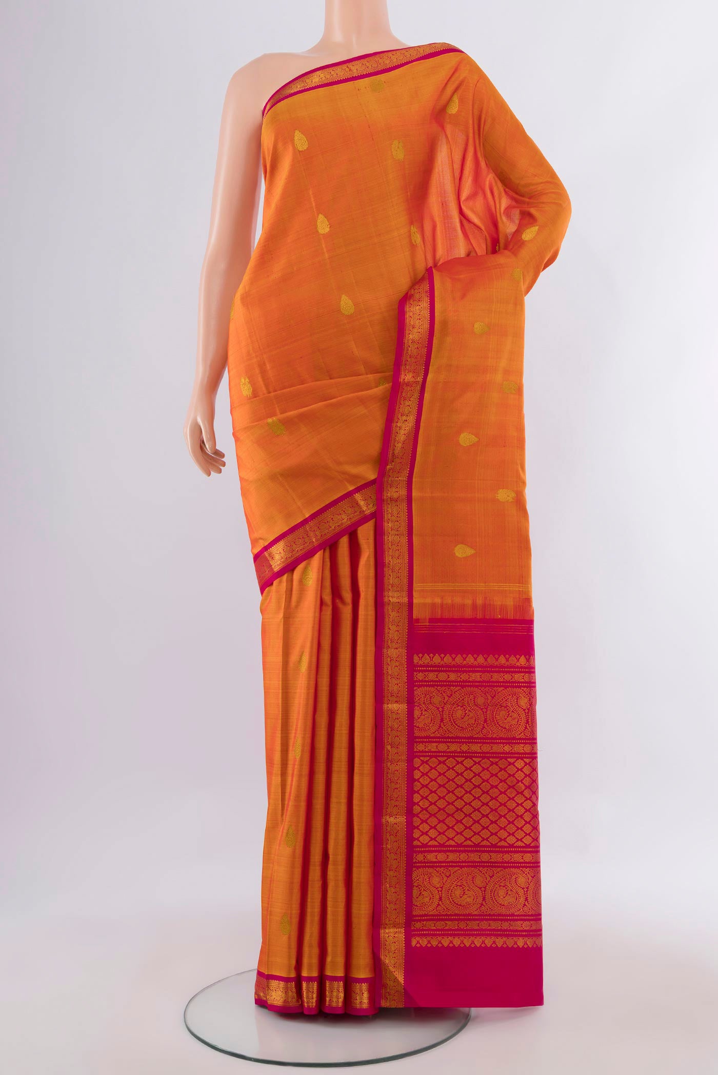 Pure Silk Mustard Kanchipuram Saree with Zari Butta on the body and Zari Border.  displayed on a mannequin