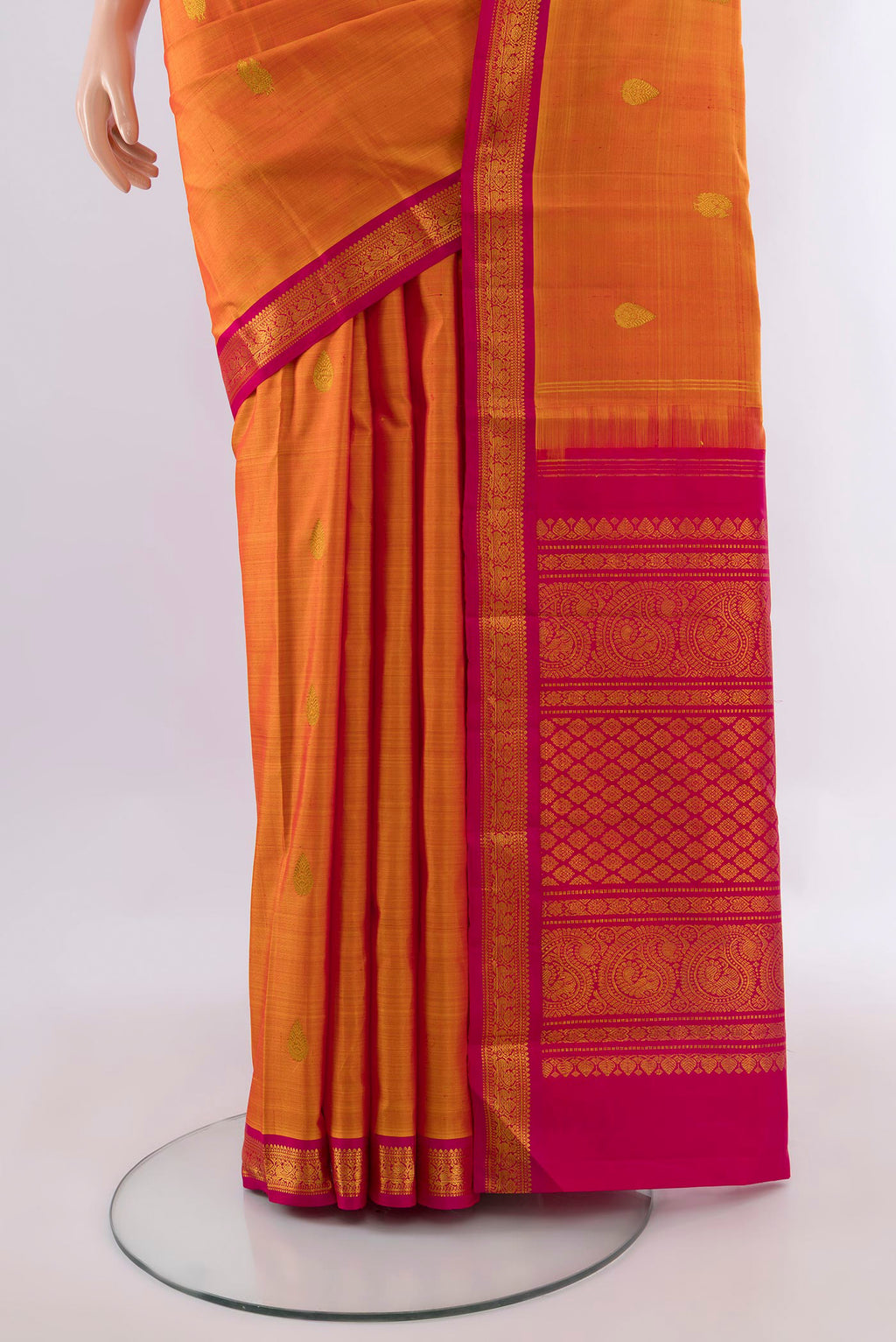 Pleats and pallu of Pure Silk Mustard Kanchipuram Saree with Zari Butta on the body and Zari Border. 