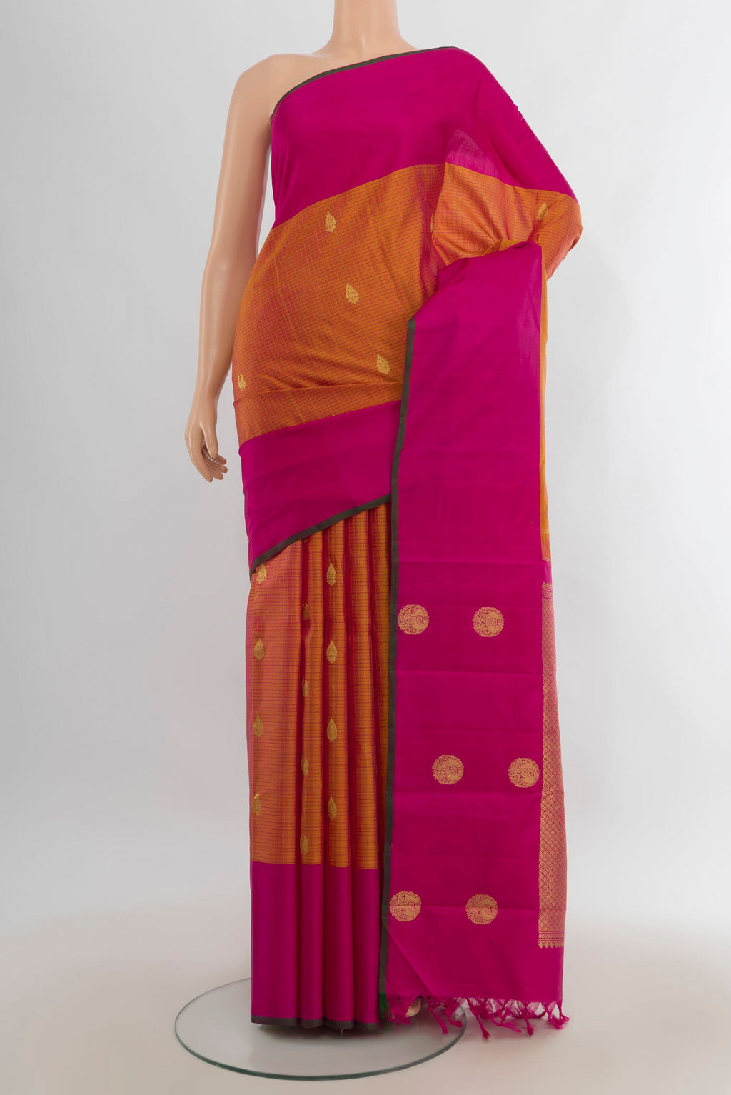 Pure Silk Pure Zari Golden Peach Kanjivaram Saree with Zari Butta on the body and Silk Border.  displayed on a mannequin