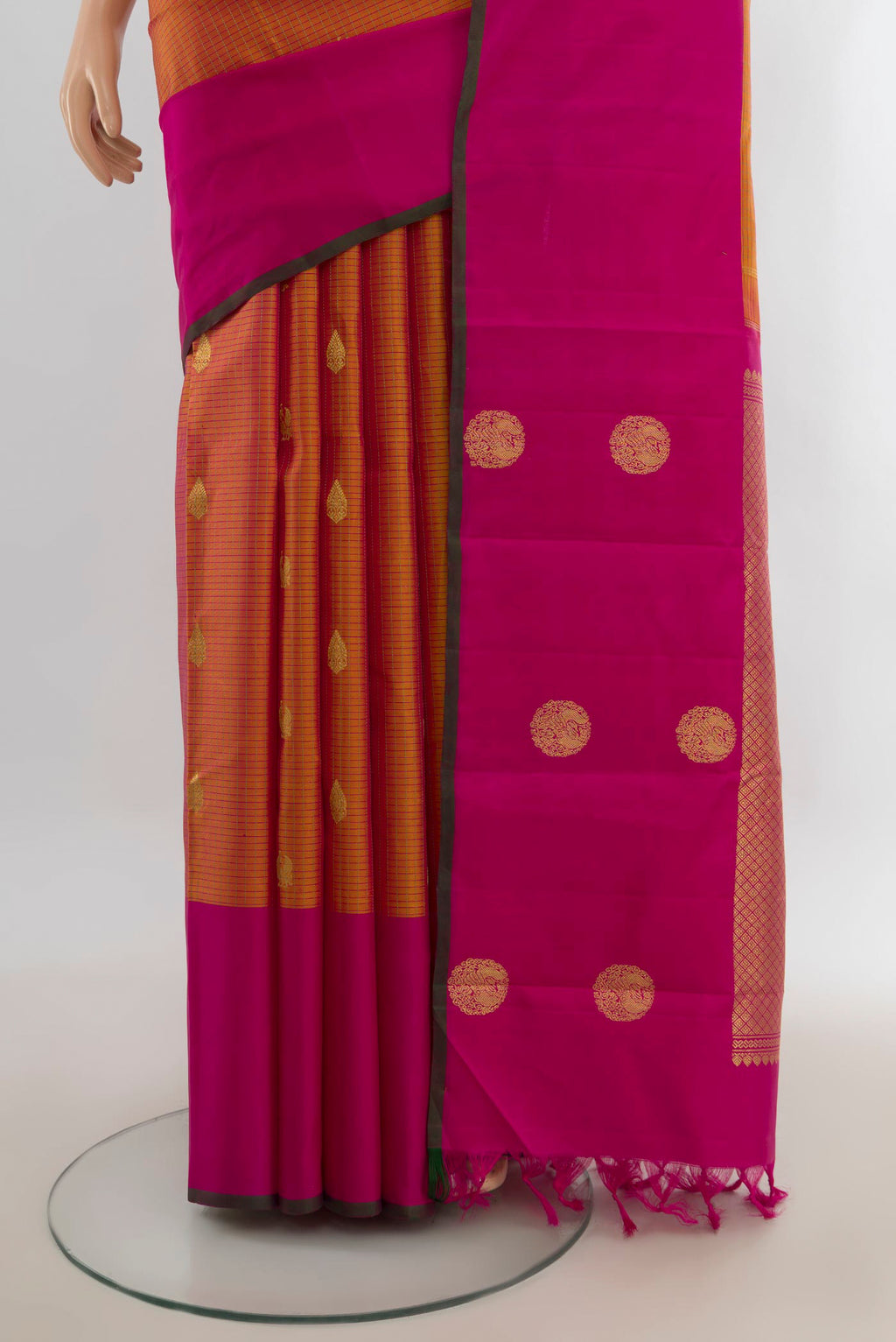 Pleats and pallu of Pure Silk Pure Zari Golden Peach Kanjivaram Saree with Zari Butta on the body and Silk Border. 