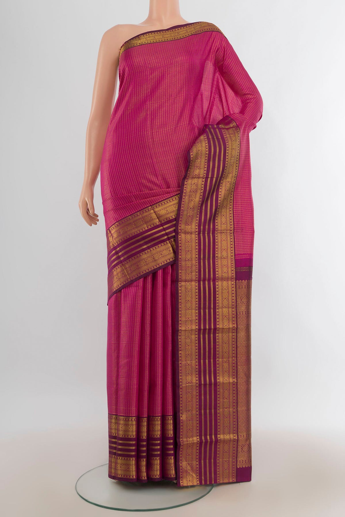 Pure Silk Magenta Kanjivaram Saree with Plain Body and Silk Border.  displayed on a mannequin