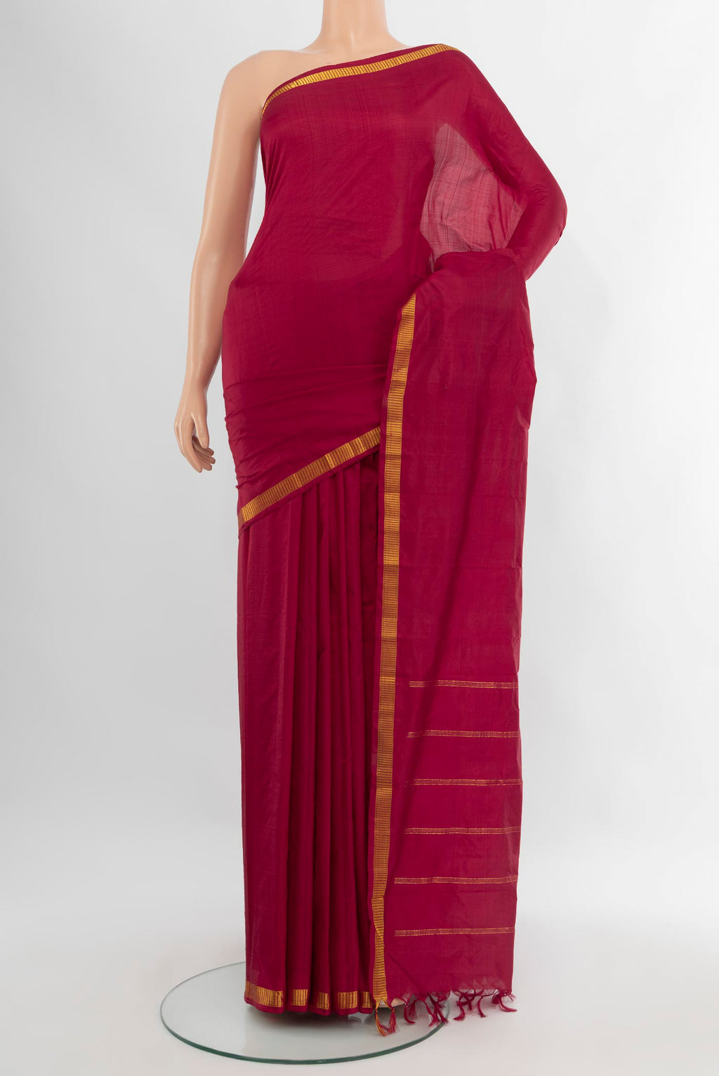 Maroon Kanchipuram Silk Saree with Plain Body and Zari Border.  displayed on a mannequin