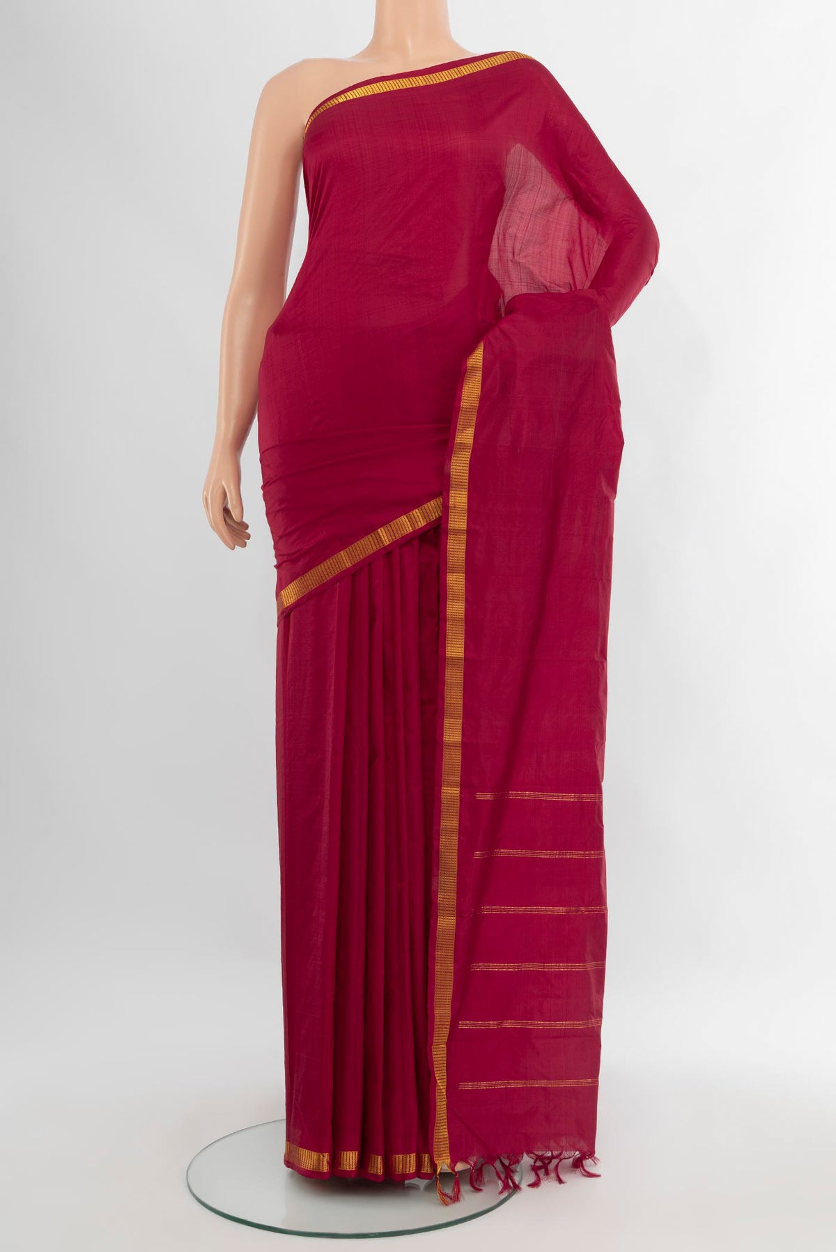 Maroon Kanchipuram Silk Saree with Plain Body and Zari Border.  displayed on a mannequin