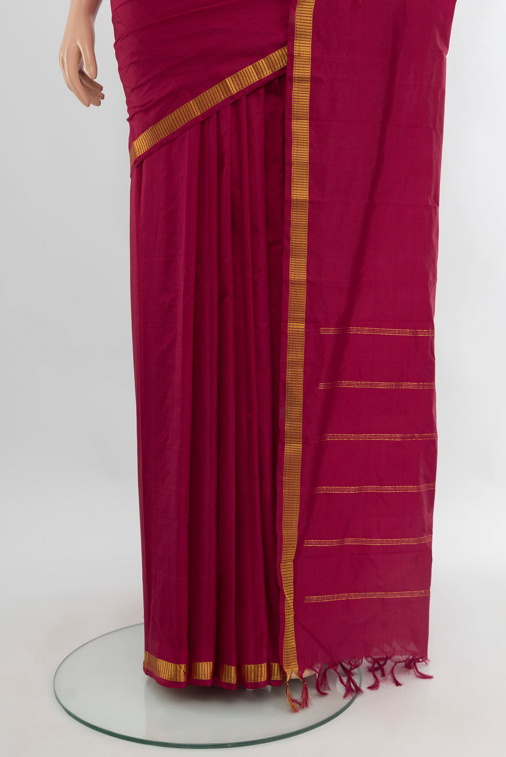 Pleats and pallu of Maroon Kanchipuram Silk Saree with Plain Body and Zari Border. 