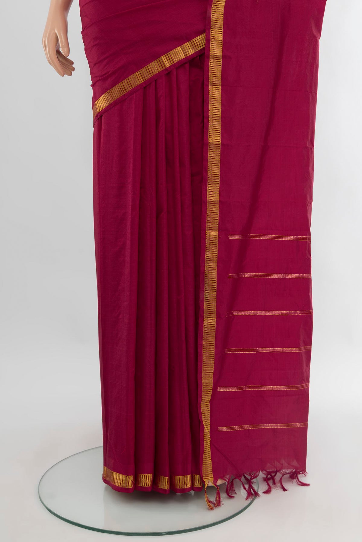 Pleats and pallu of Maroon Kanchipuram Silk Saree with Plain Body and Zari Border. 