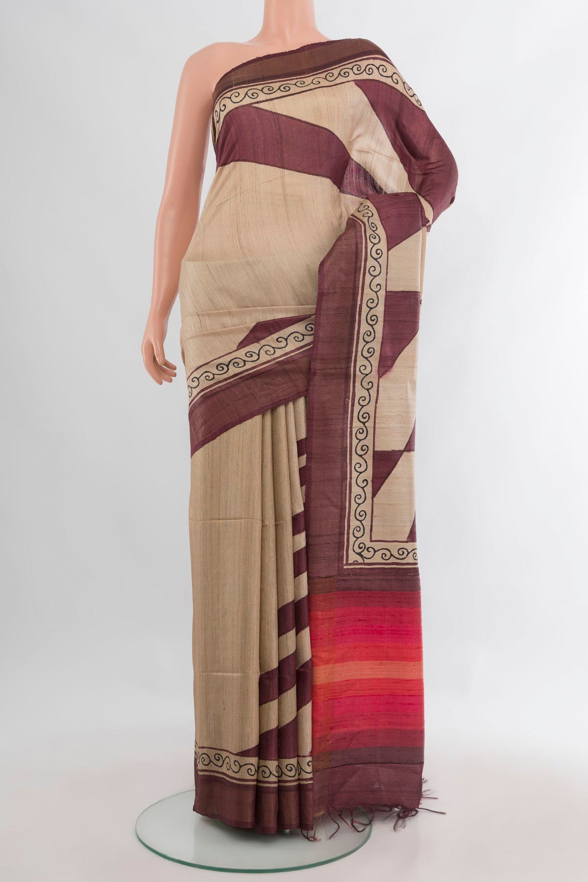 Beige Tussar Saree with Printed design on the body and Zari Border.  displayed on a mannequin