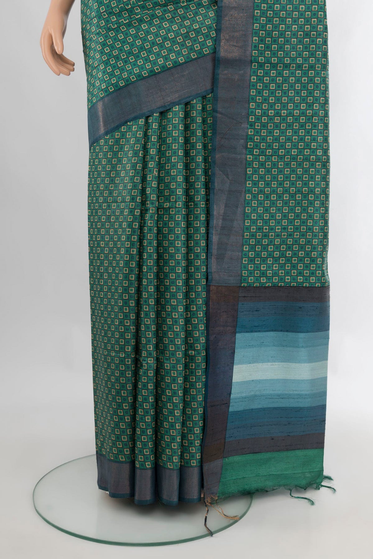 Pleats and pallu of Green Tussar Saree with Printed design on the body and Zari Border. 