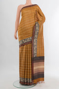 Mustard Tussar Saree with Printed design on the body and Zari Border.  displayed on a mannequin