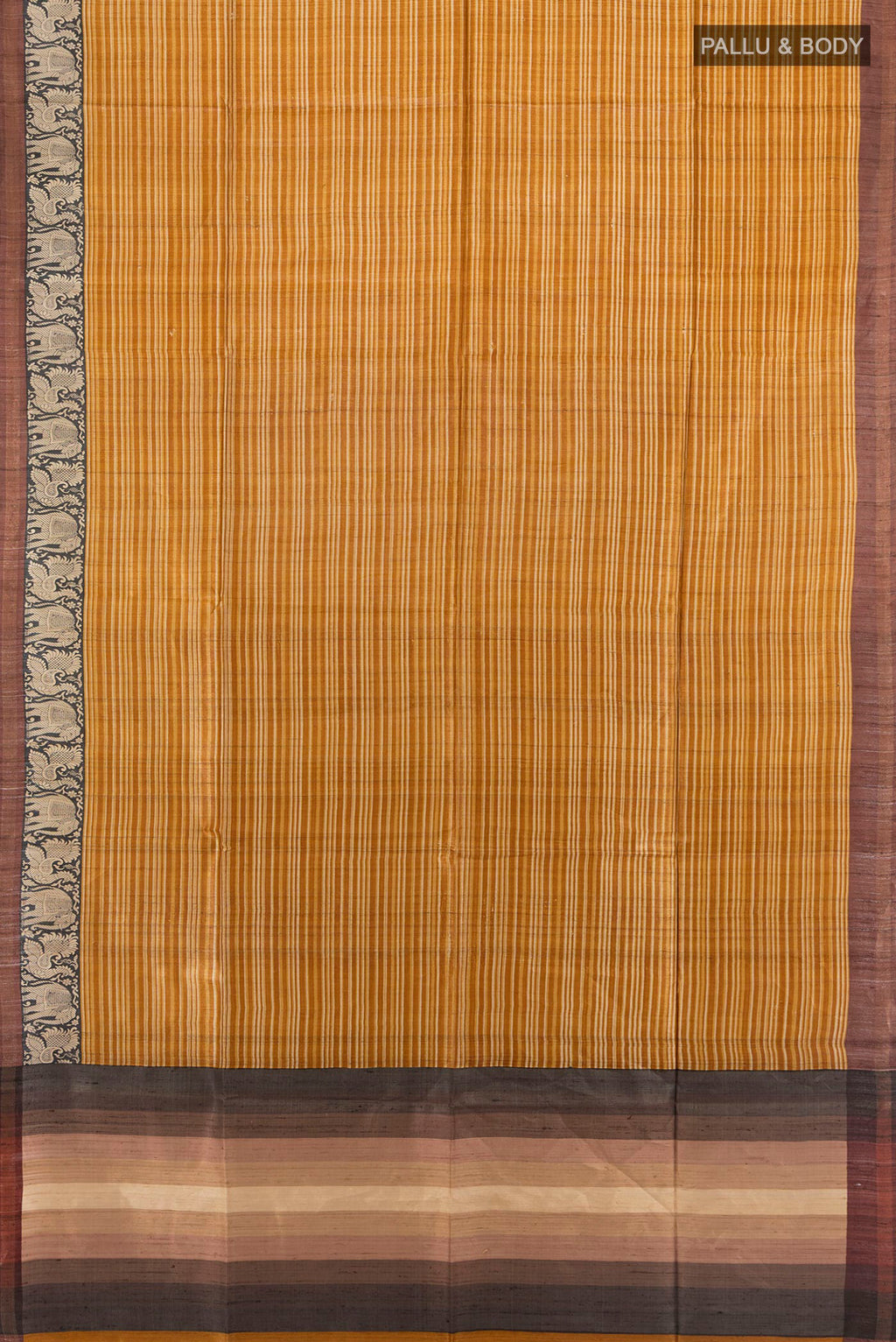 Flat view of Mustard Tussar Saree with Printed design on the body and Zari Border. 