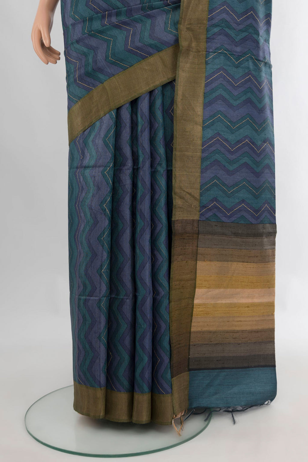 Pleats and pallu of Multi Color Tussar Saree with Printed design on the body and Zari Border. 