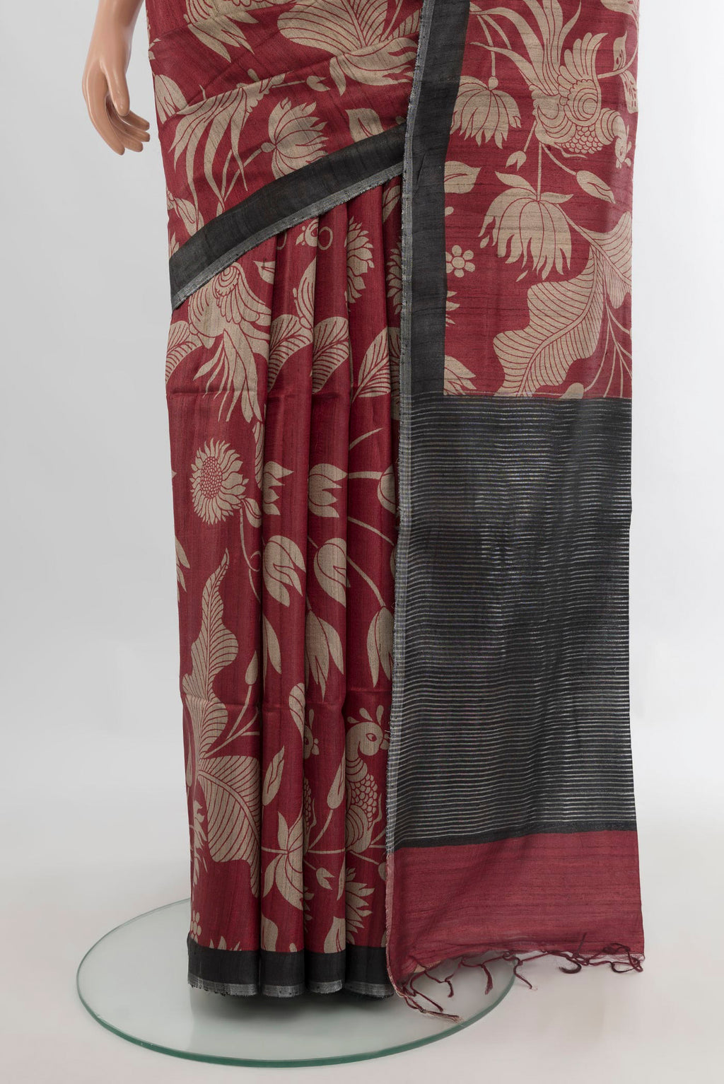 Pleats and pallu of Maroon Tussar Saree with Floral Print on the body and Zari Border. 