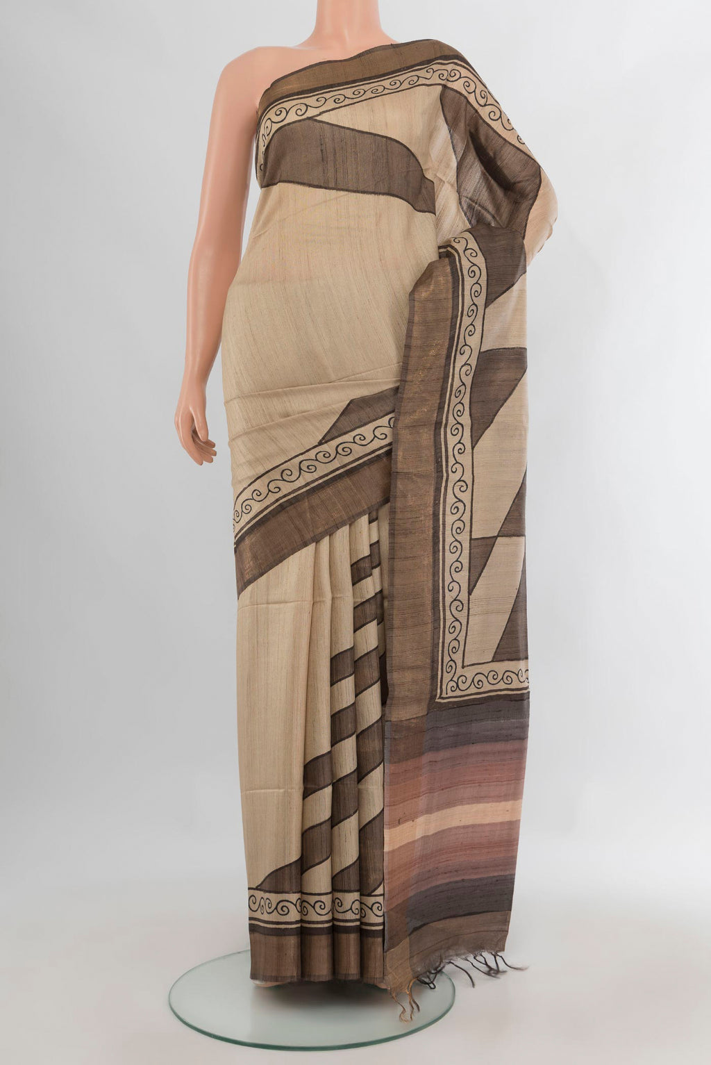 Beige Tussar Saree with Printed design on the body and Zari Border.  displayed on a mannequin