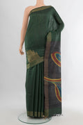 Pure Silk Bottle Green Tussar Saree with Floral Print on the body and Zari Border.  displayed on a mannequin
