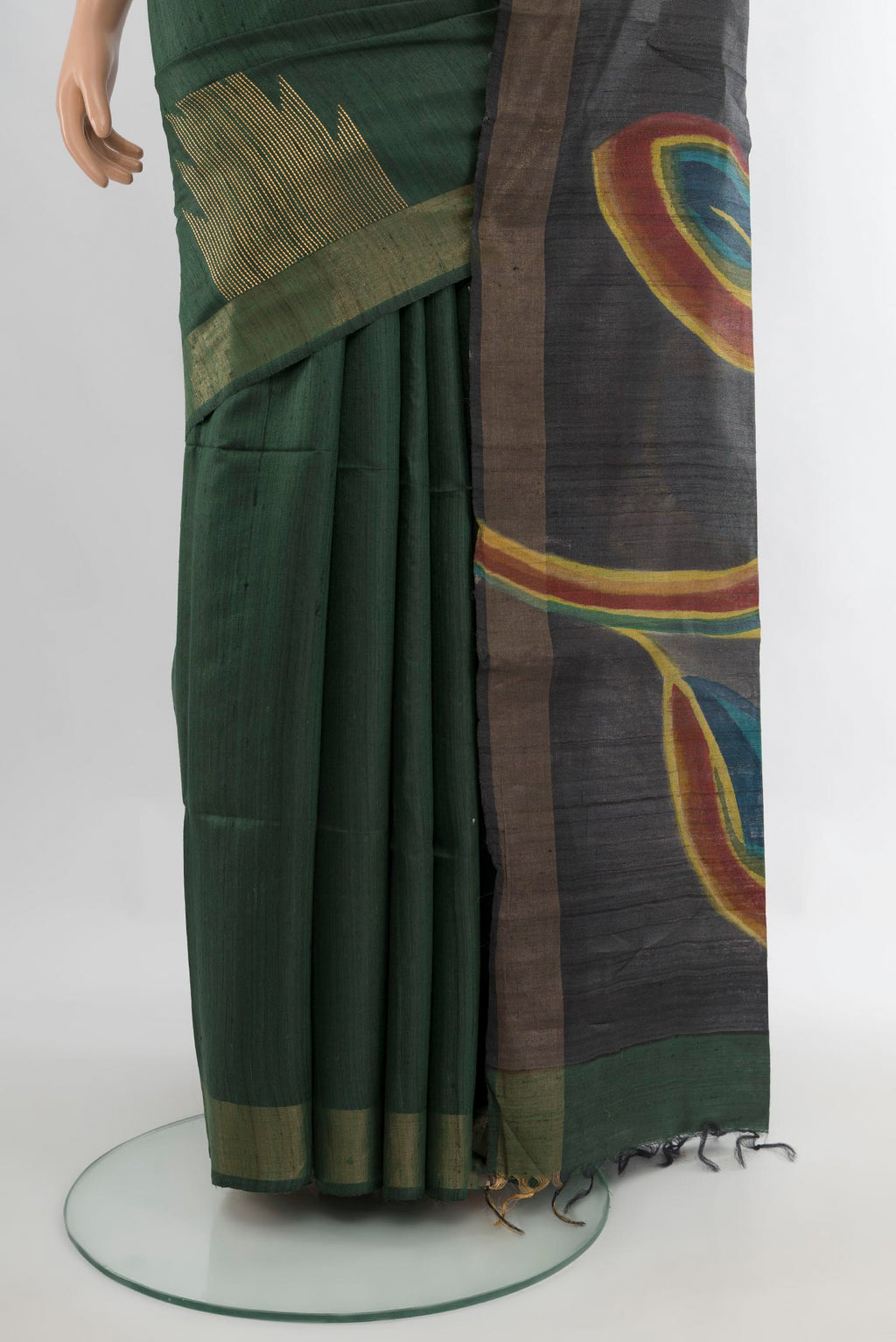 Pleats and pallu of Pure Silk Bottle Green Tussar Saree with Floral Print on the body and Zari Border. 