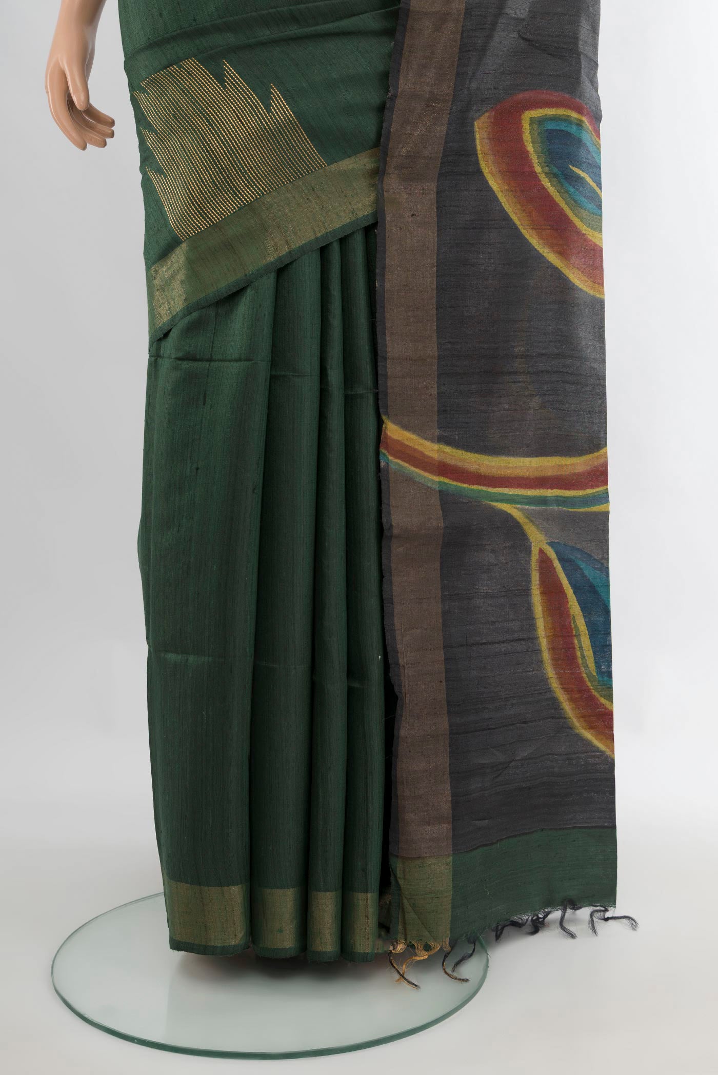 Pleats and pallu of Pure Silk Bottle Green Tussar Saree with Floral Print on the body and Zari Border. 