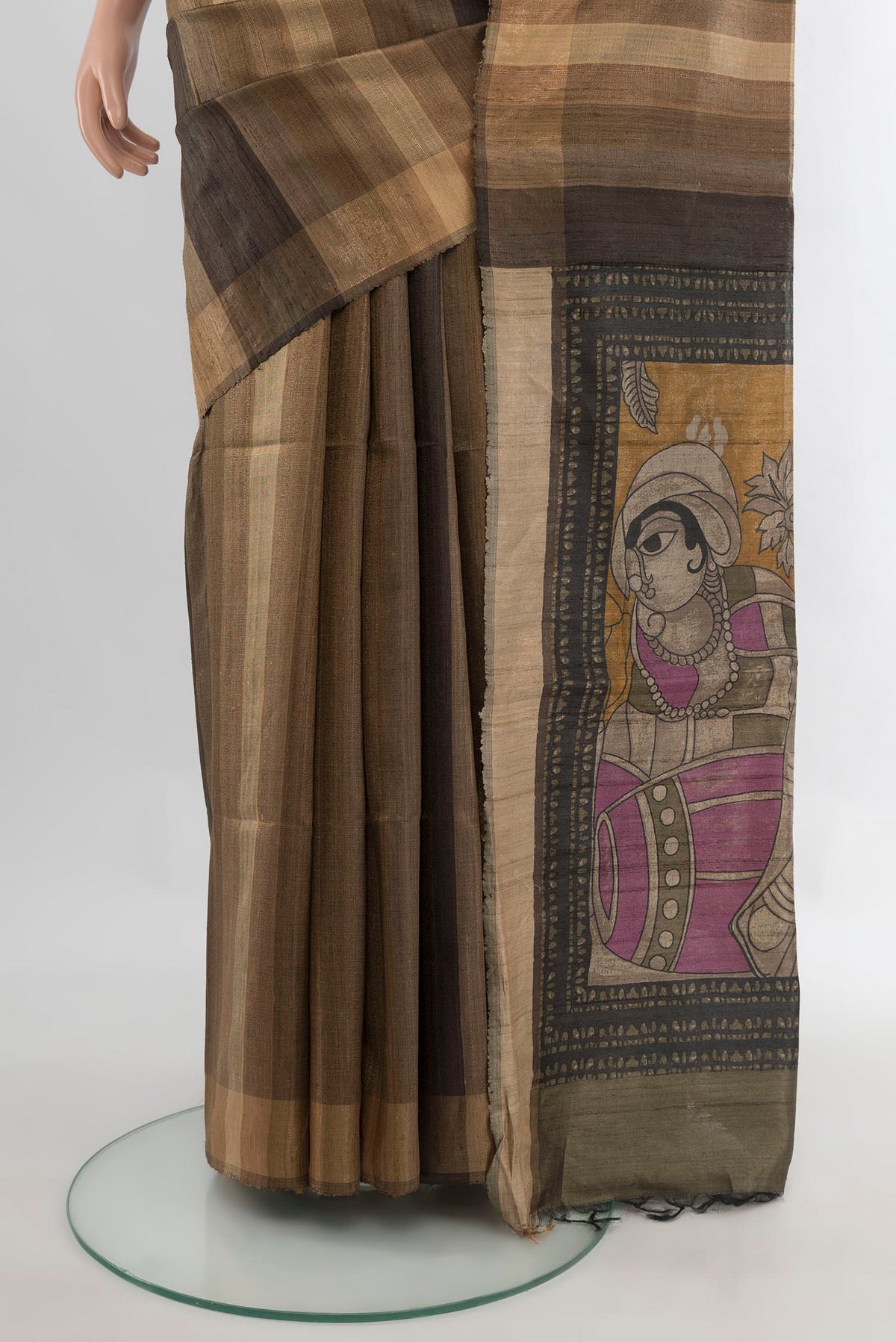 Pleats and pallu of Beige Tussar Saree with Stripes on the body and Zari Border. 