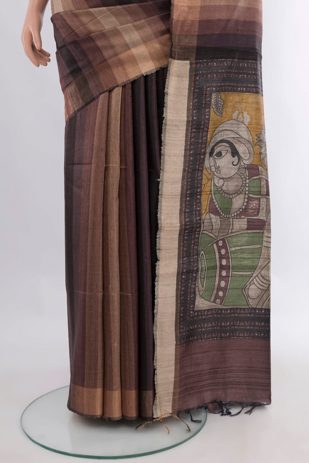 Pleats and pallu of Brown Tussar Saree with Stripes on the body and Zari Border. 