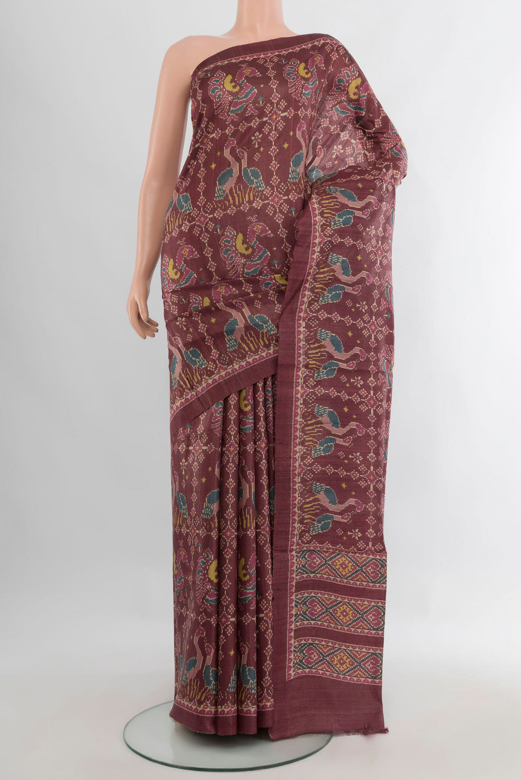 Brown Tussar Saree with Floral Print on the body and Printed Border.  displayed on a mannequin