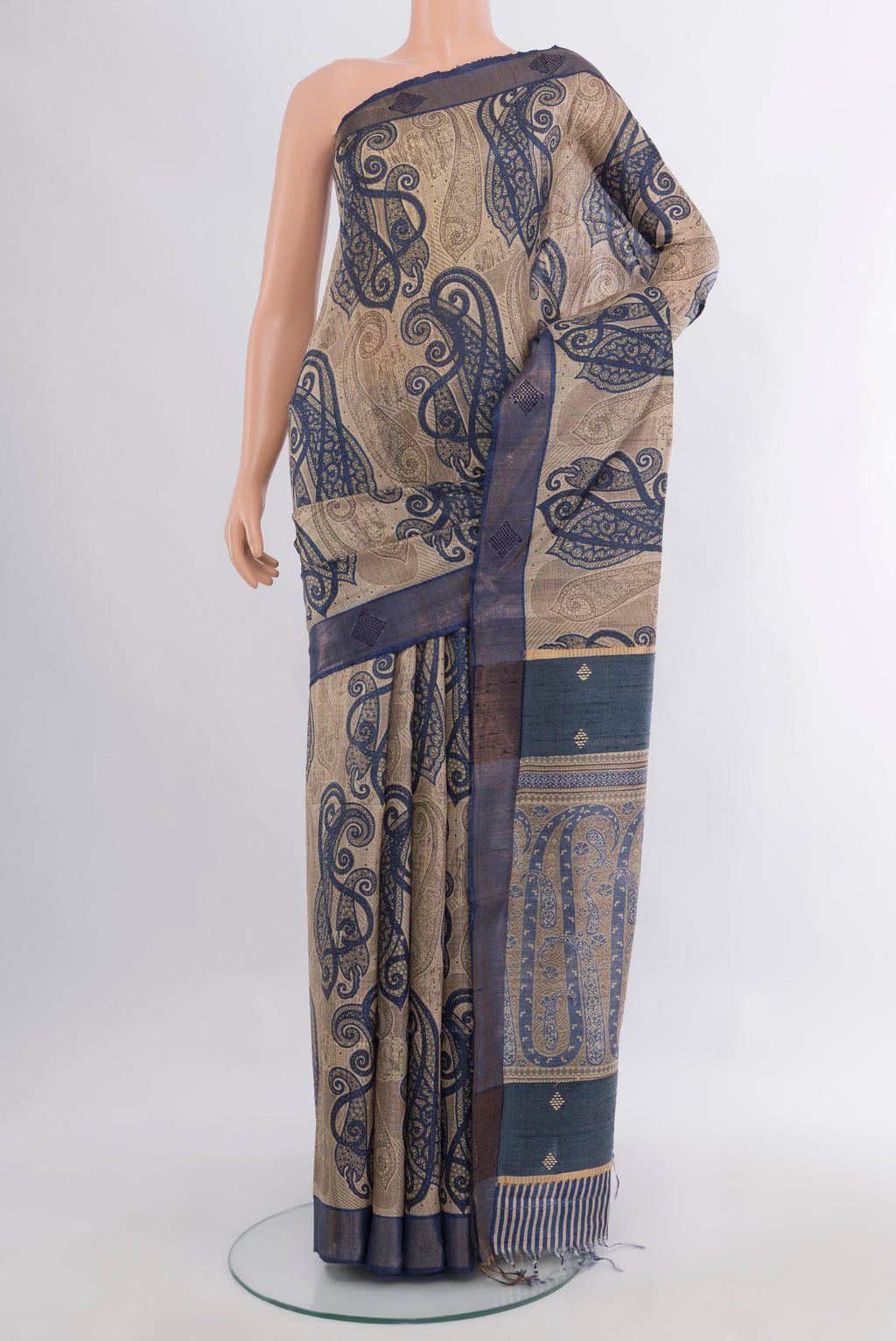 Beige Tussar Saree with Floral Print on the body and Zari Border.  displayed on a mannequin