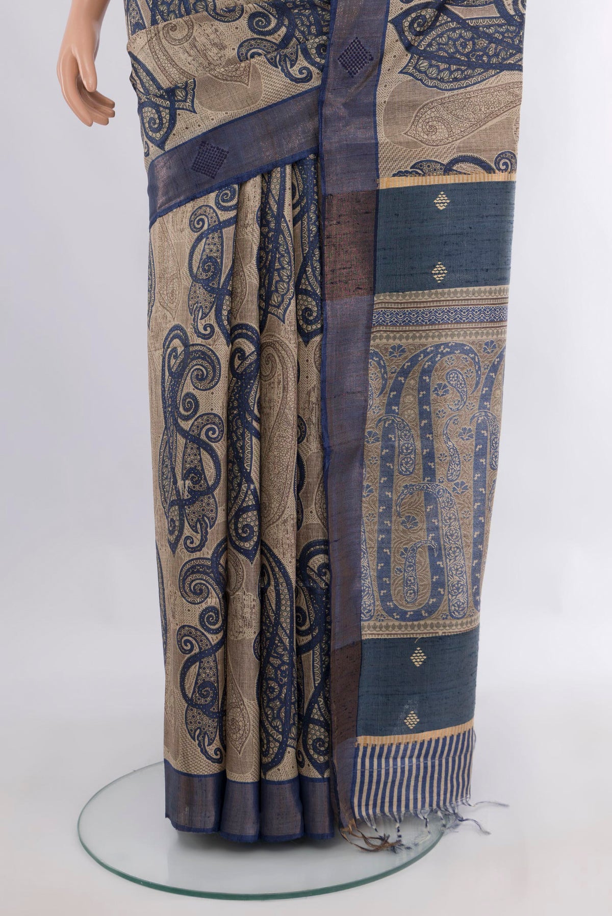 Pleats and pallu of Beige Tussar Saree with Floral Print on the body and Zari Border. 