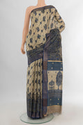 Beige Tussar Saree with Floral Print on the body and Zari Border.  displayed on a mannequin