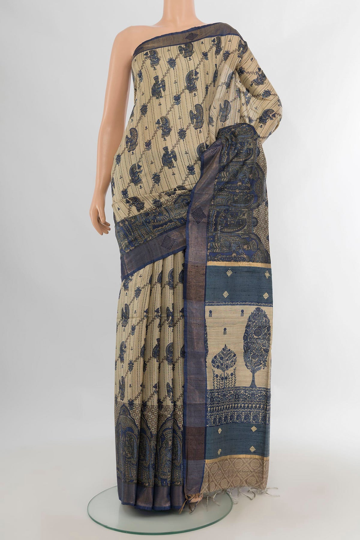 Beige Tussar Saree with Floral Print on the body and Zari Border.  displayed on a mannequin