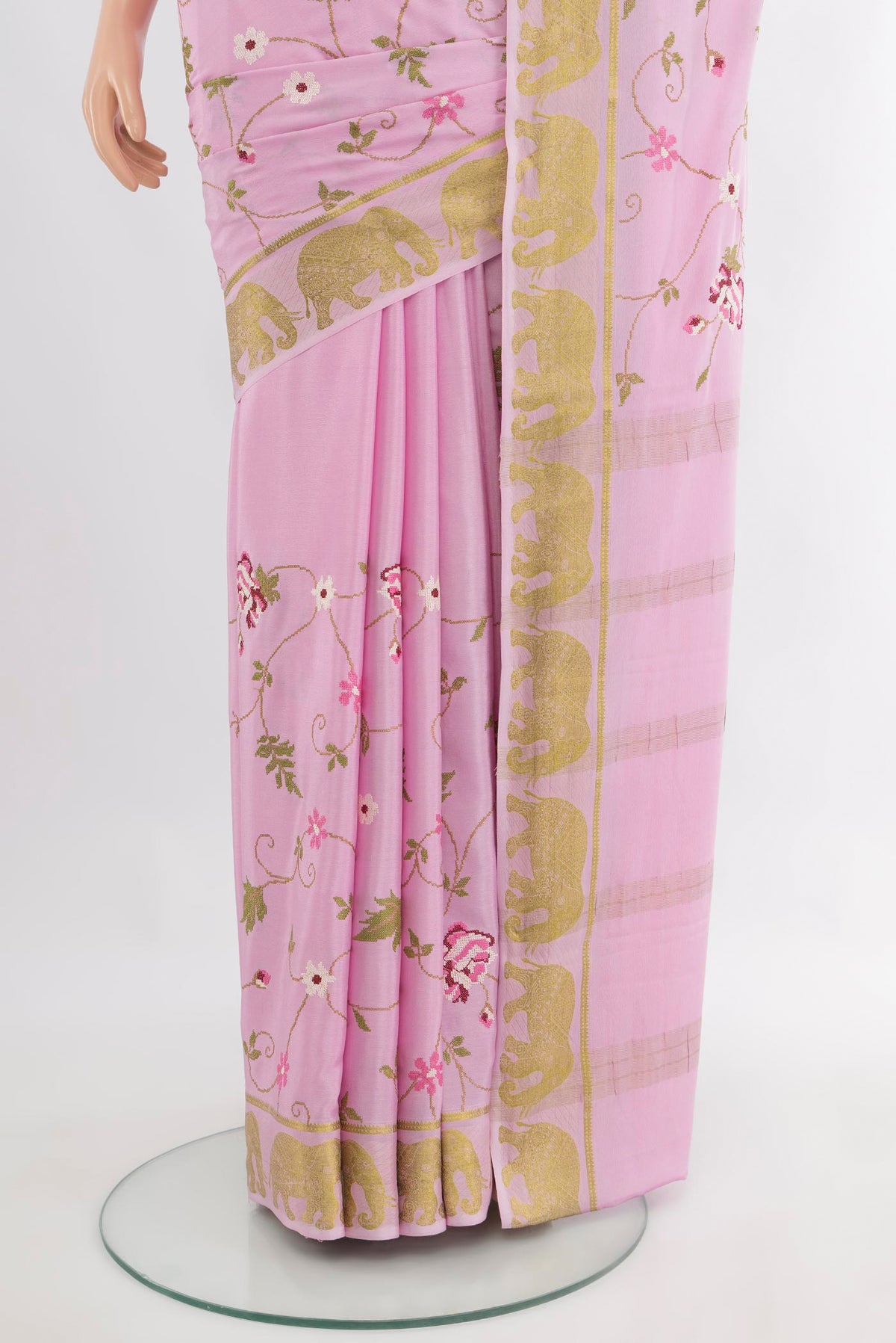 Pleats and pallu of Rose pink Mysore Crepe Saree with Embroidery on the body and Zari Border. 