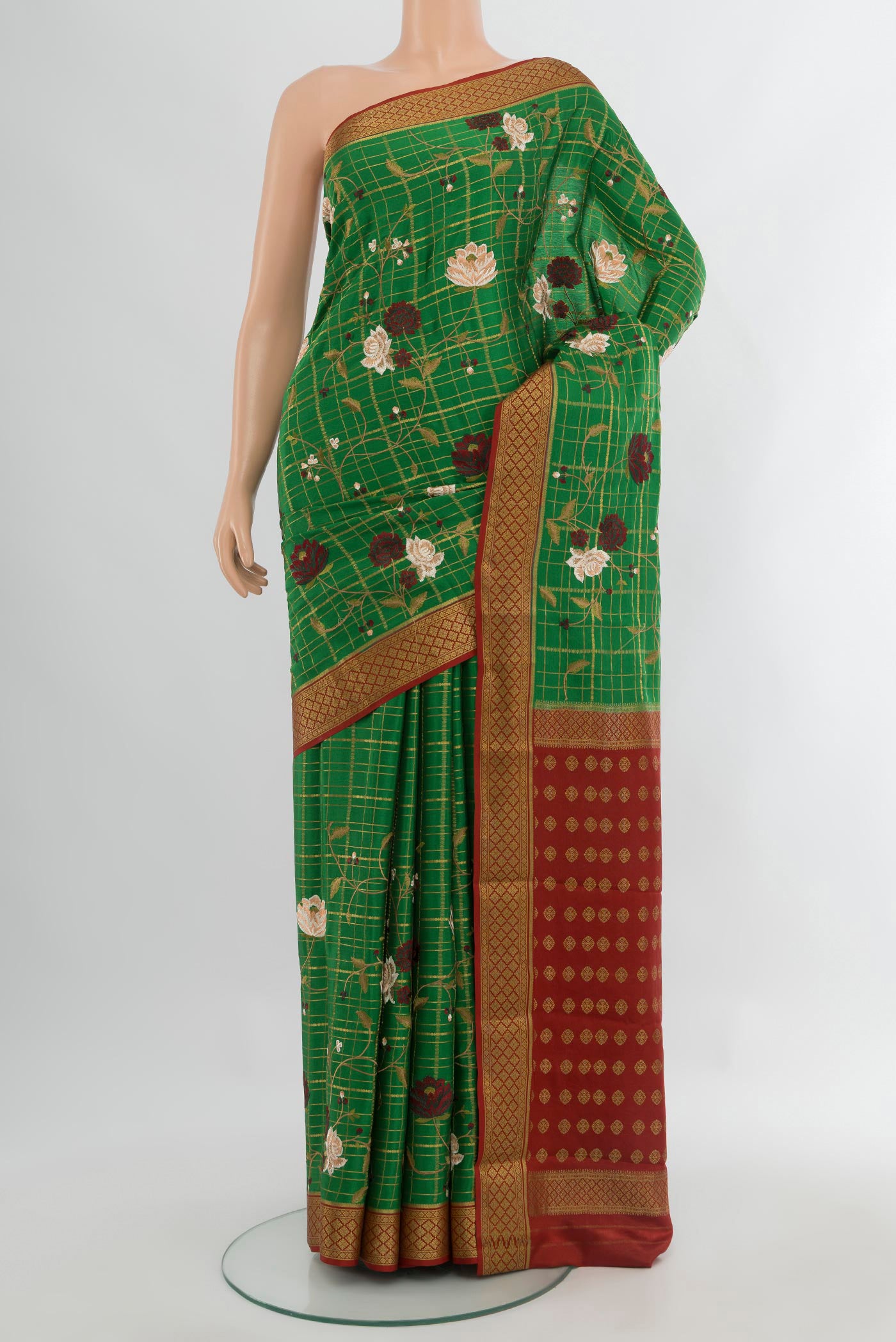 Green Mysore Crepe Saree with Embroidery on the body and Zari Border.  displayed on a mannequin