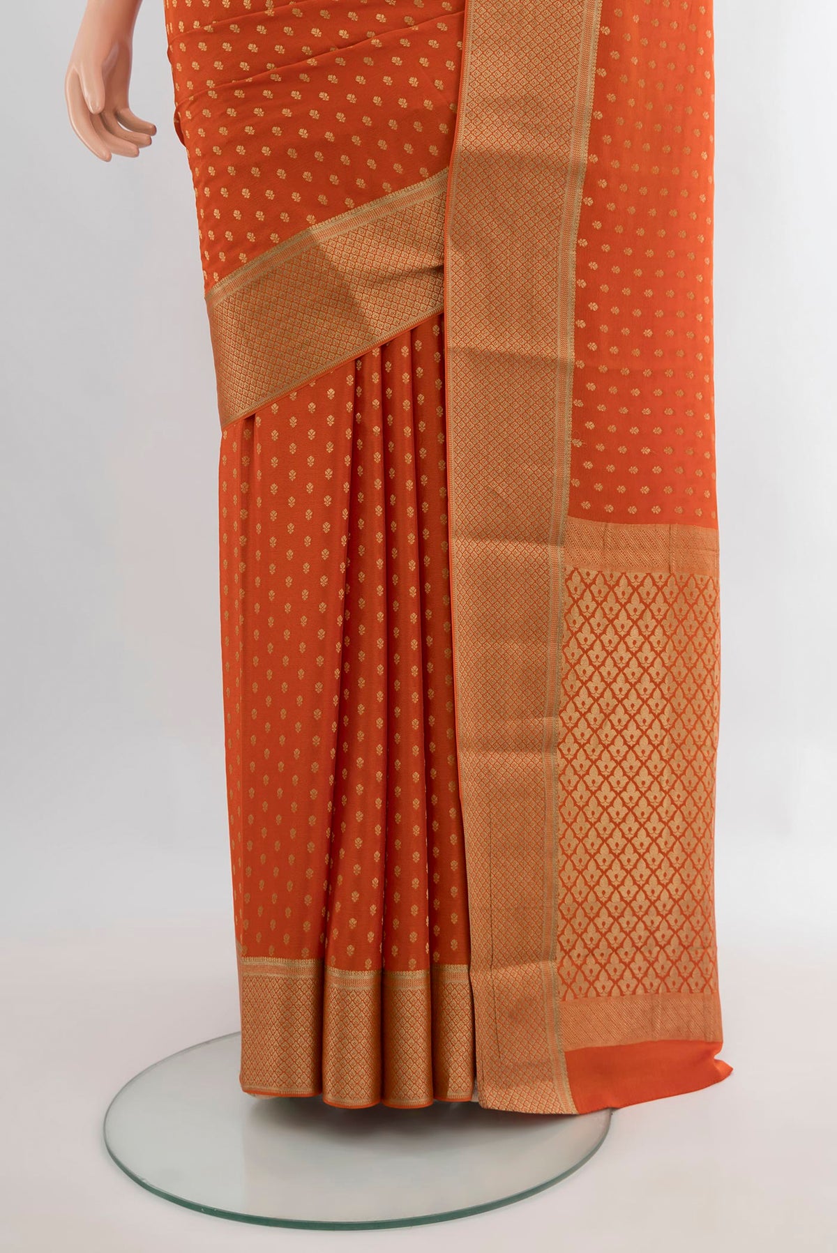Pleats and pallu of Brick Orange Mysore Crepe Saree with Zari Butta on the body and Zari Border. 