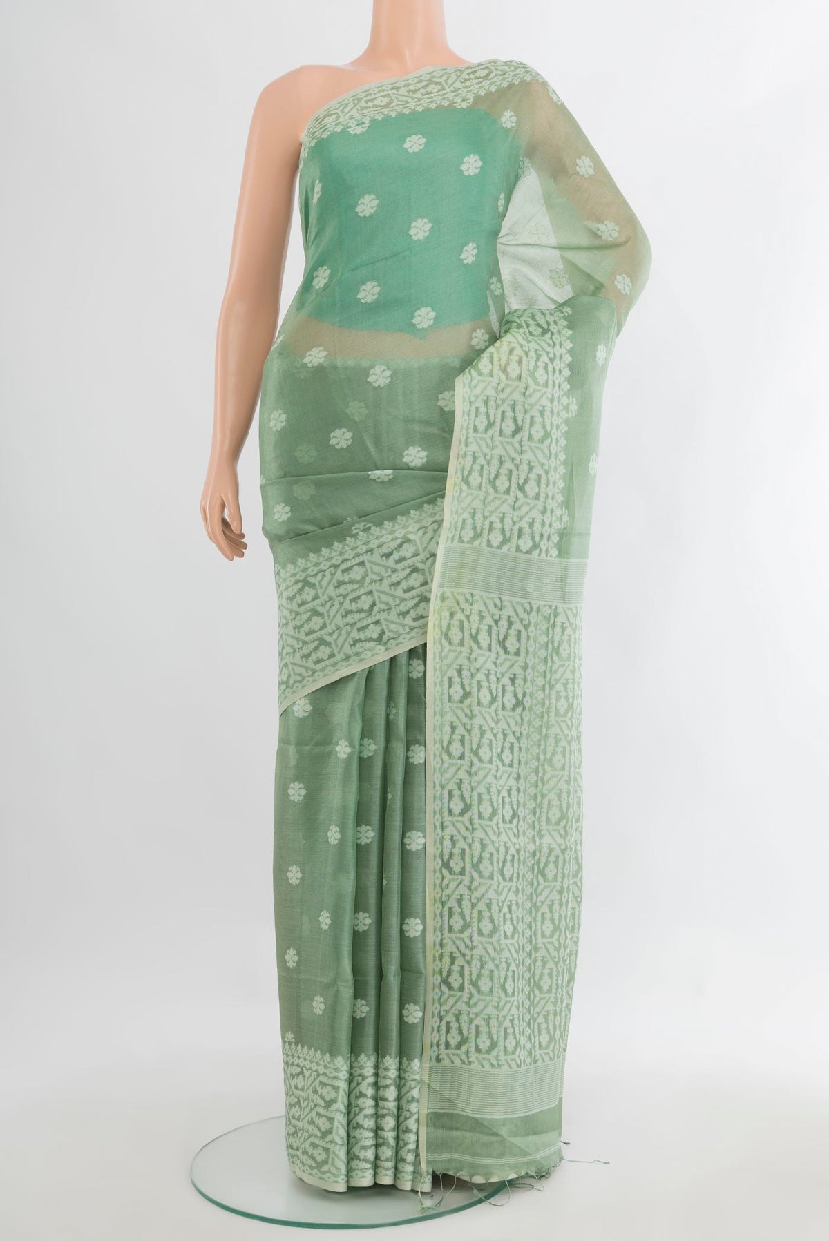 Pista Green Tussar Saree with Thread Butta on the body and Thread Border.  displayed on a mannequin