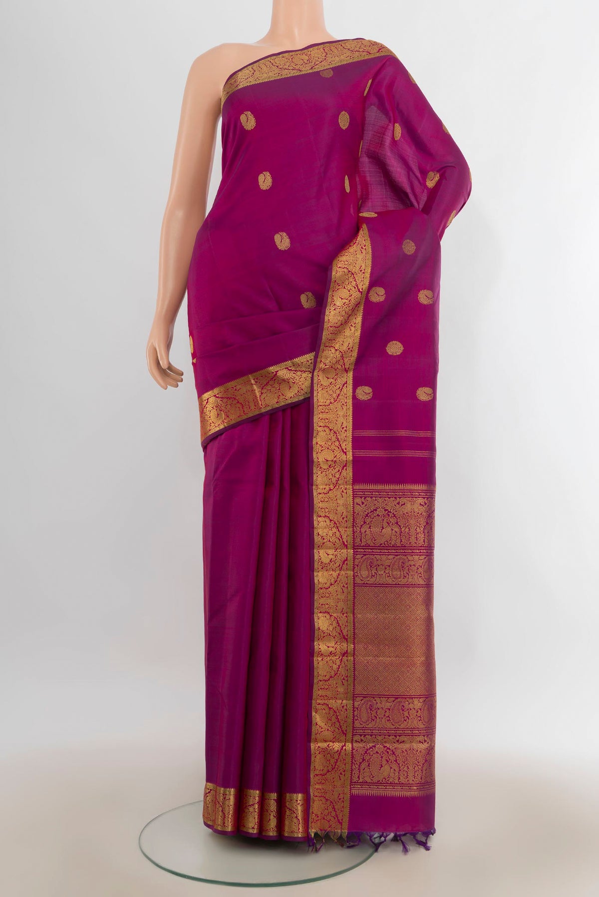 Pure Silk Pure Zari Magenta Kanjivaram Saree with Zari Butta on the body and Zari Border.  displayed on a mannequin