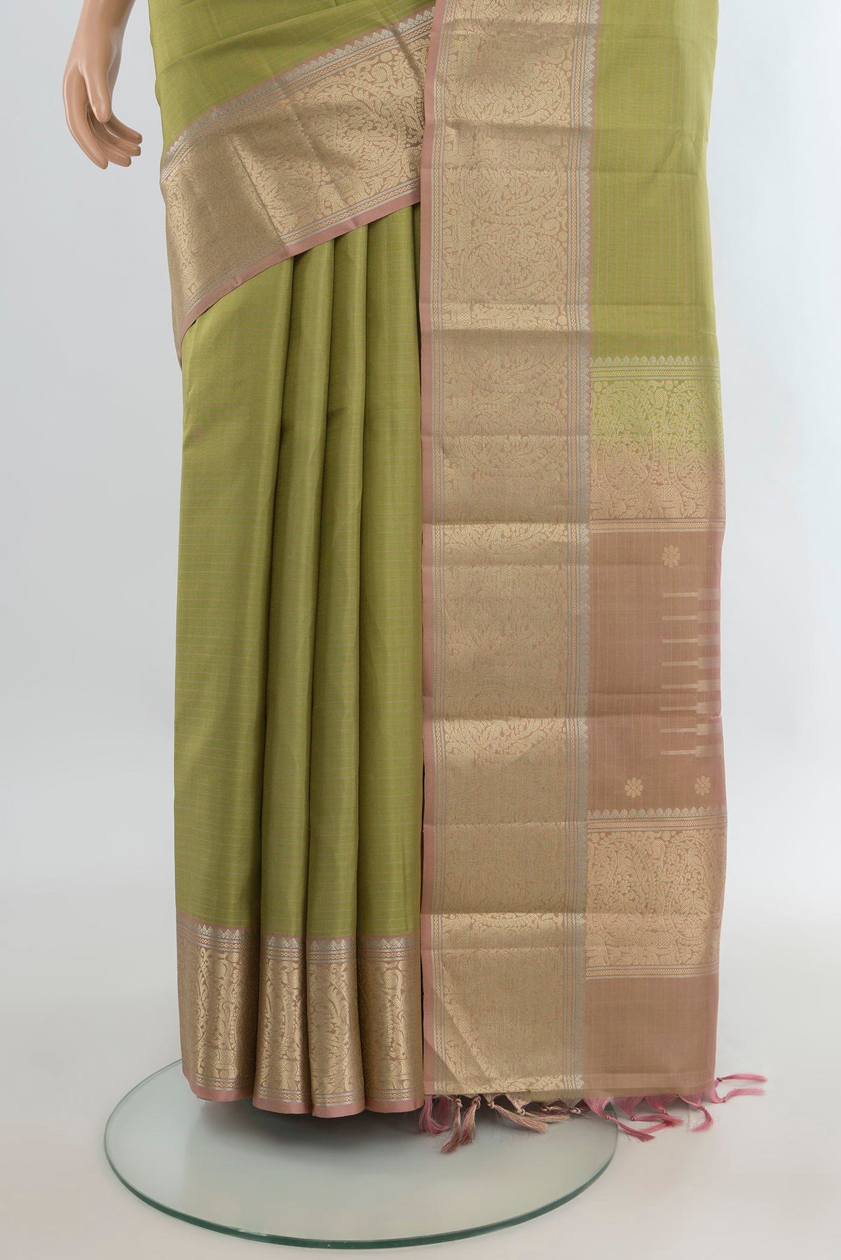 Pleats and pallu of Pure Silk Light Green Kanchipuram Saree with Stripes on the body and Zari Border. 