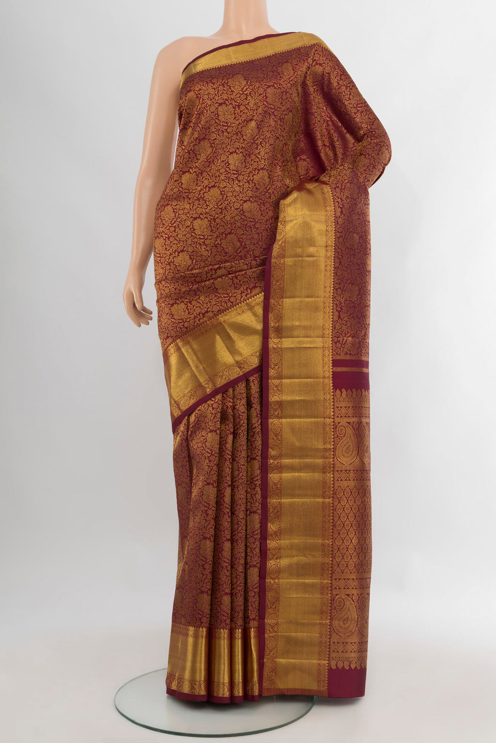 Maroon Kanchipuram Silk Saree with Zari Brocade on the body and Zari Border.  displayed on a mannequin